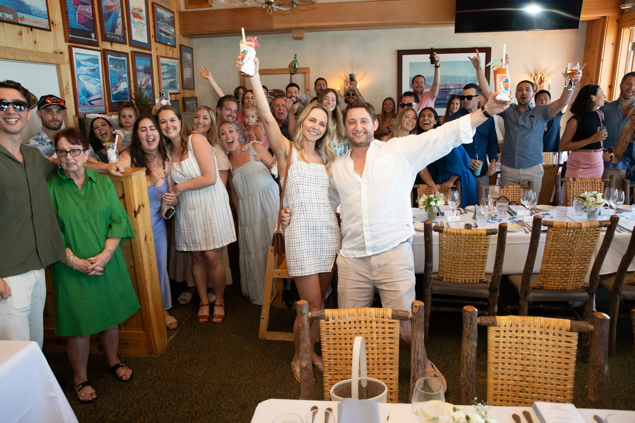 Newly engaged couple celebrating with friends at Garwood's on Lake Tahoe after a surprise proposal