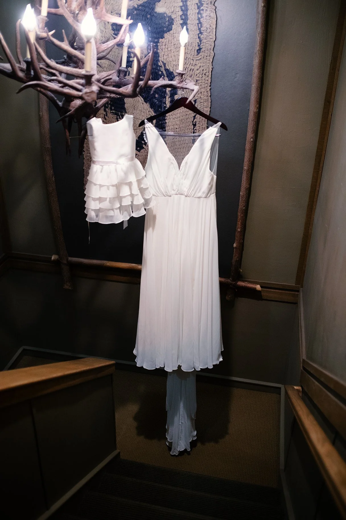 wedding dress hanging from chandelier