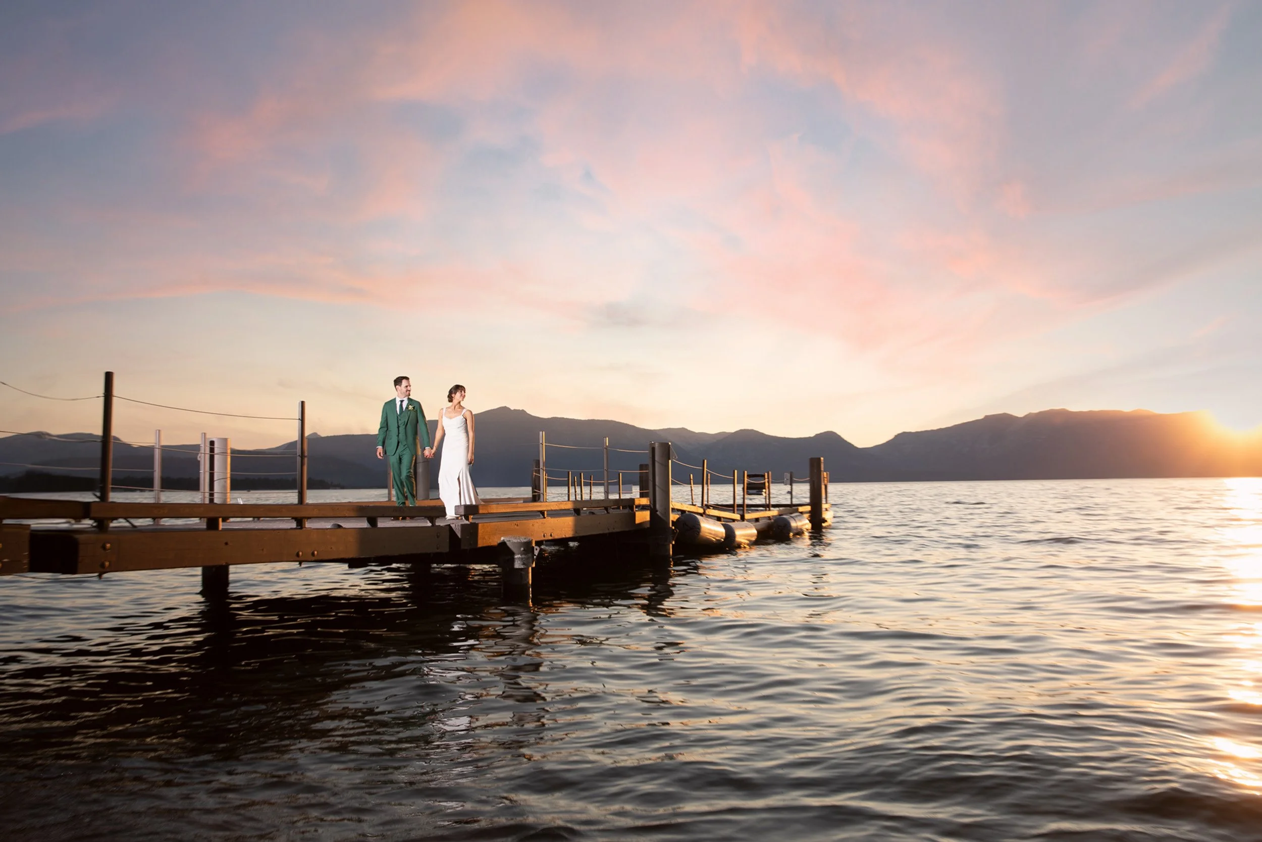 bride and groom on pier in Tahoe