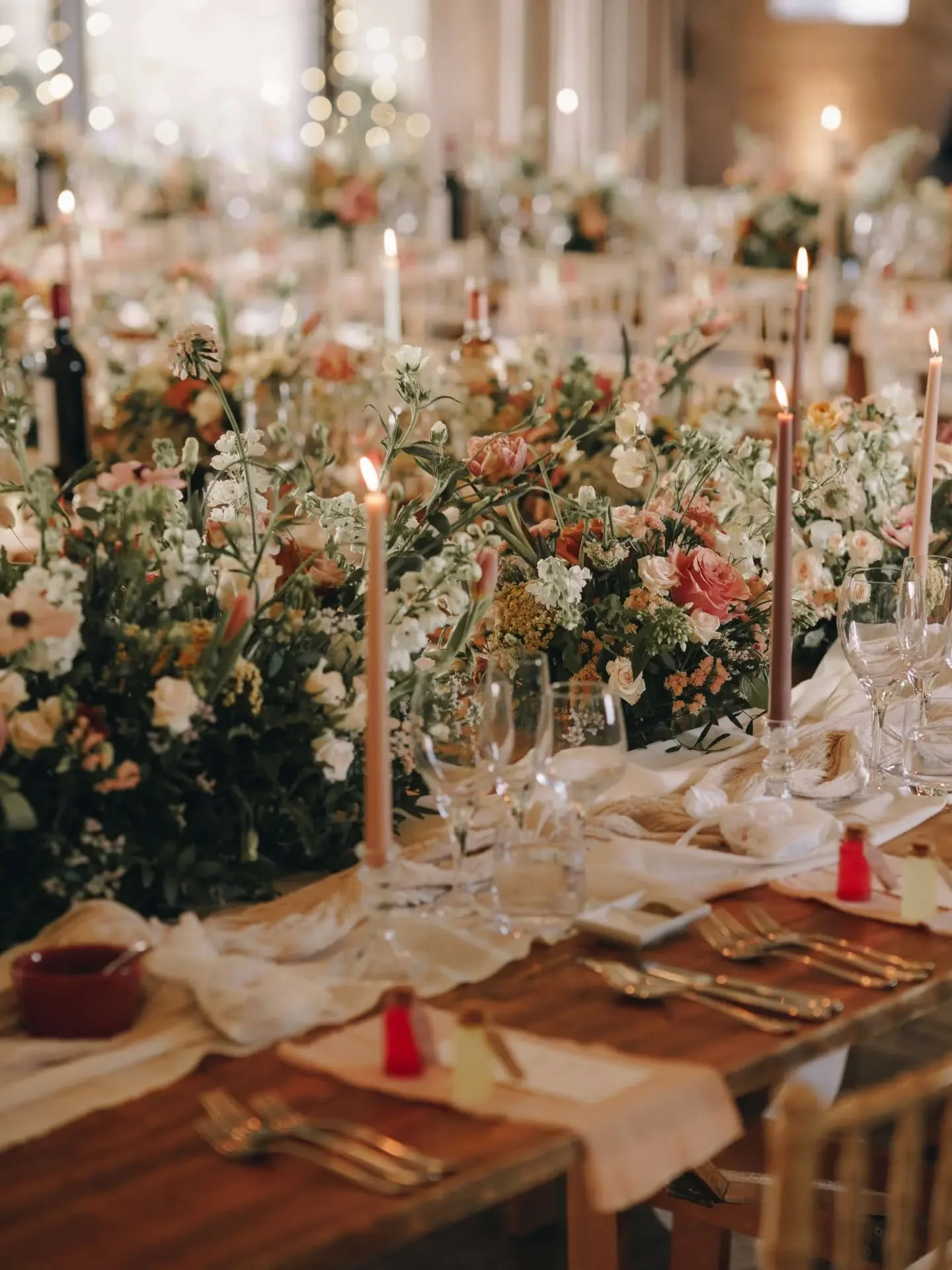 A wedding full to the brim of flowers for S&amp;D. 
Continuous runners led the way down the aisle to a floral hoop and asymmetric arch.
We were able to repurpose the aisle runners for the wedding reception table pieces, allowing the flowers to fill t