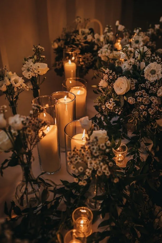 Candles lit in hurricane vases, creating a warm glow for a prop hire photo