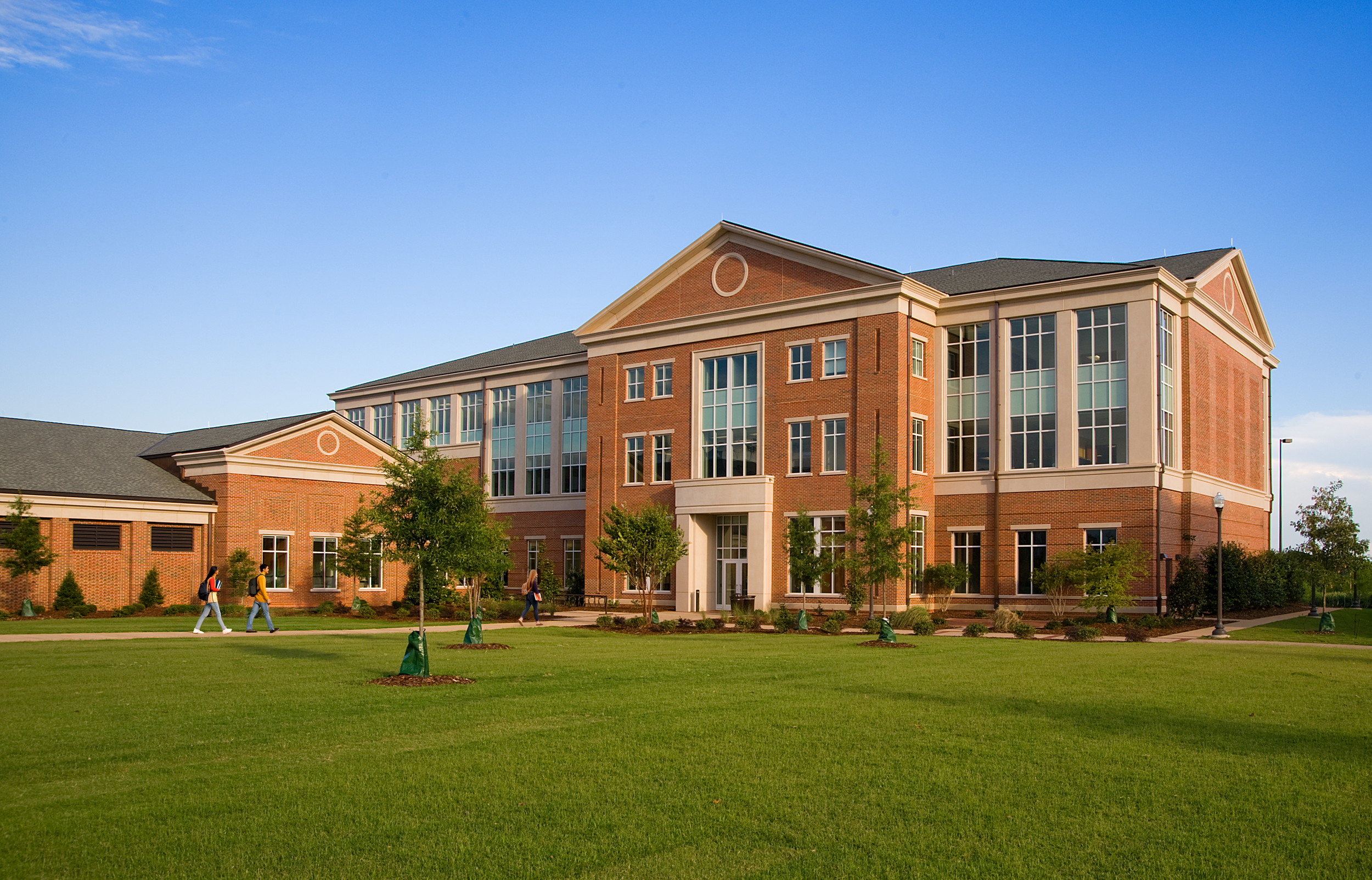 Auburn University's Office for Information is a brick and cast stone building with three floors, large expanses of windows, emphasizing Georgian style design principles that integrate with the campus fabric. - project by B Group Architecture, Inc.
