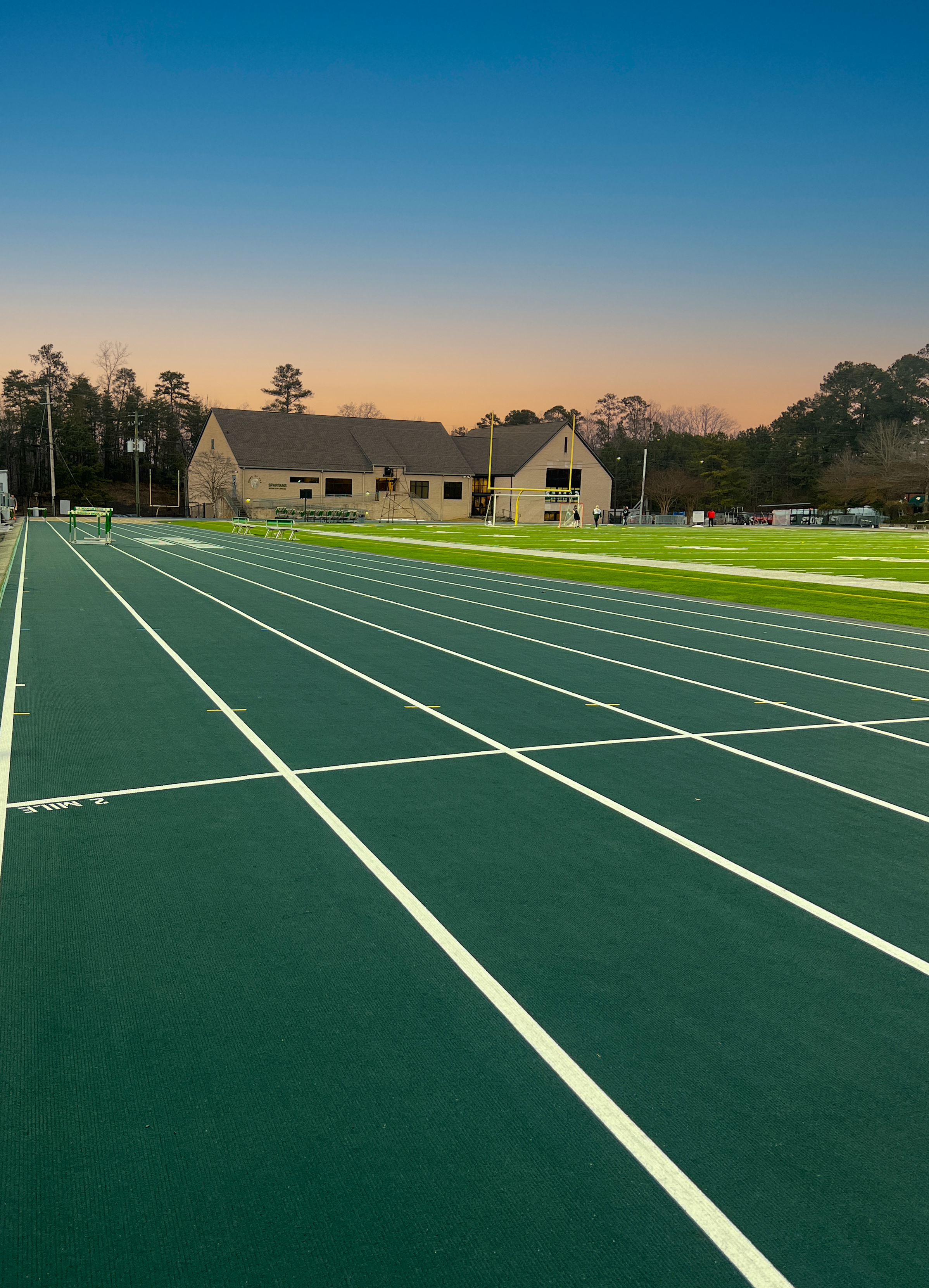 Panoramic view of Mountain Brook High School football field with a running track. project by B Group Architecture, Inc.