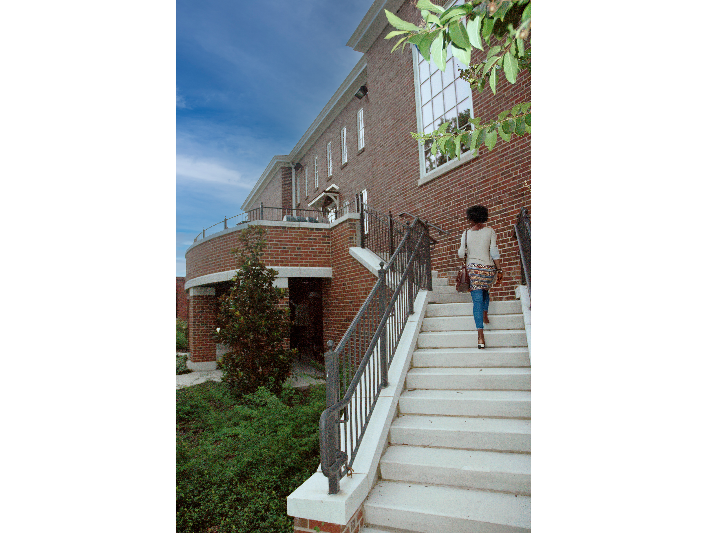 Norton library renovation has traditional red brick and cast stone trim, large windows, and an outdoor lounge space accessed by a grand stair set on a Snead State college campus. - project by B Group Architecture, Inc.