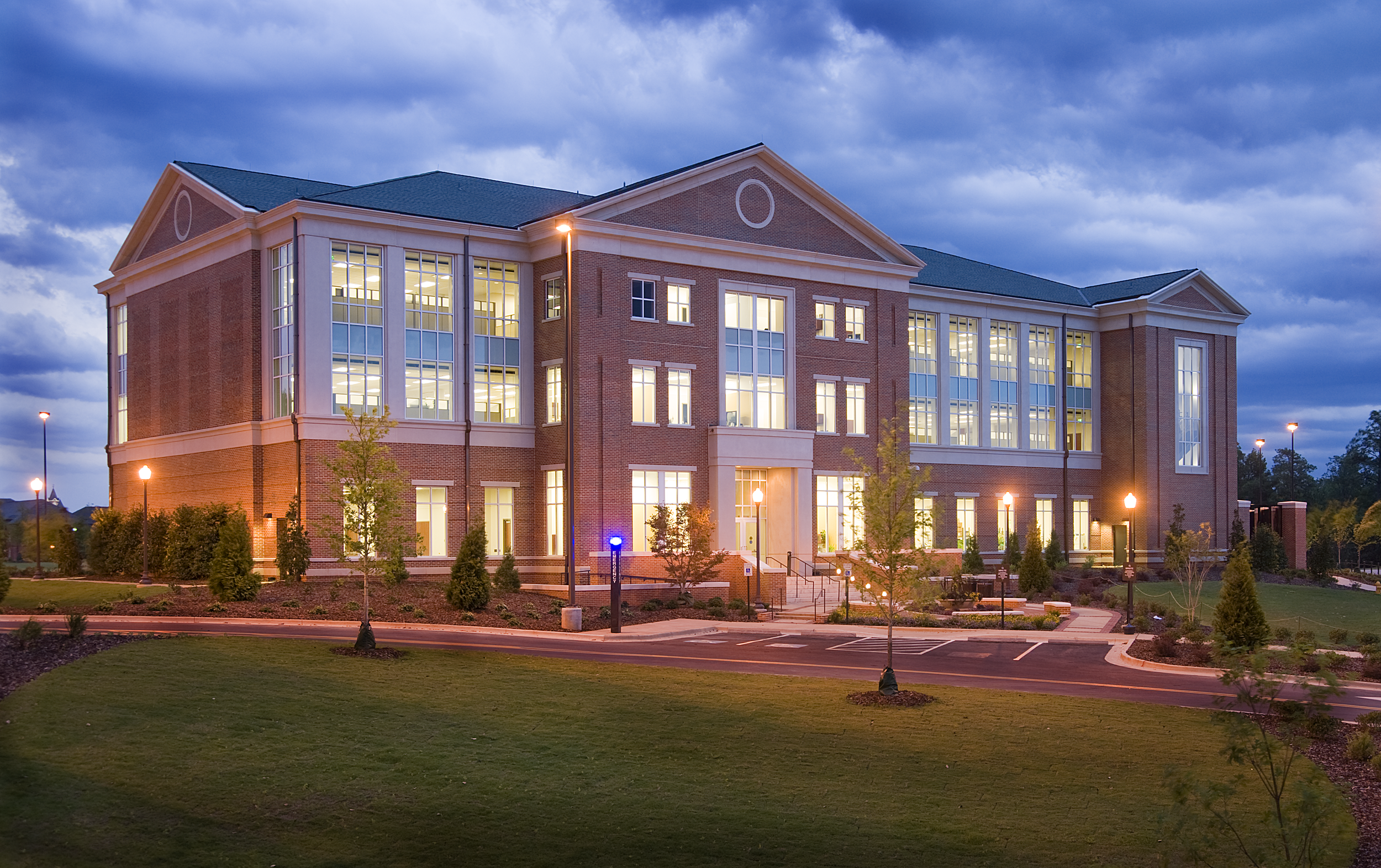 Auburn University's Office for Information is an illuminated brick and cast stone building with three floors, large windows, emphasizing Georgian style design principles that integrate with the campus fabric. - project by B Group Architecture, Inc.