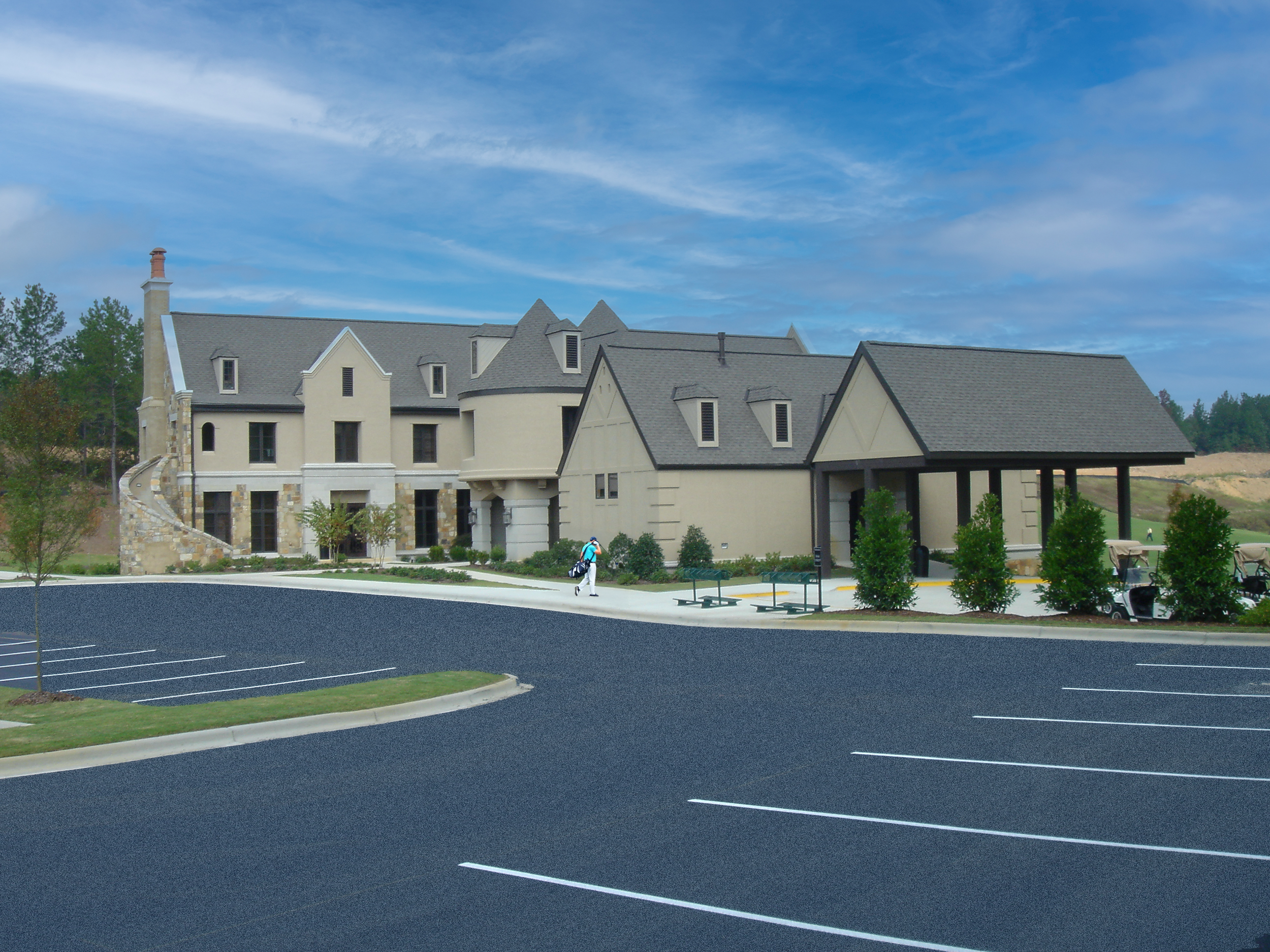 Ballantrae Golf Club castle like exterior facade with stone and stucco exterior, multiple turrets, and a stone chimney. project by B Group Architecture Inc.