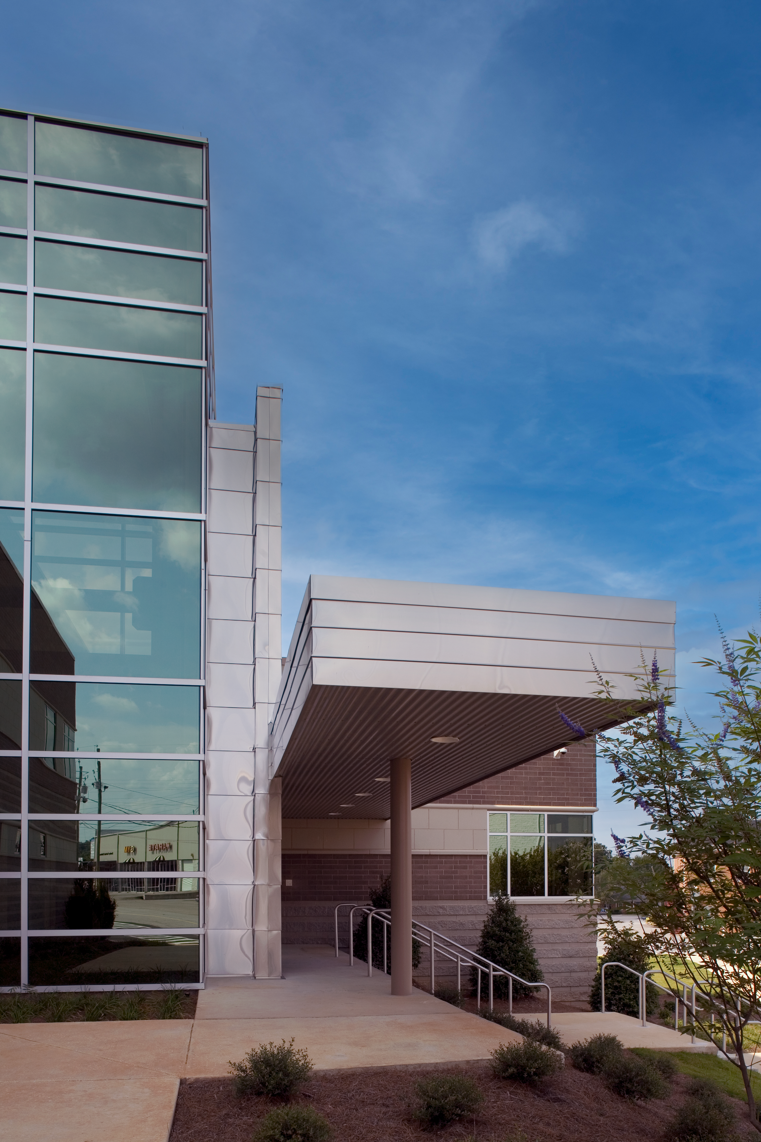 Pelham, AL Police Department's modern building with glass windows and a covered entrance clad in metal panels. project by B Group Architecture Inc,