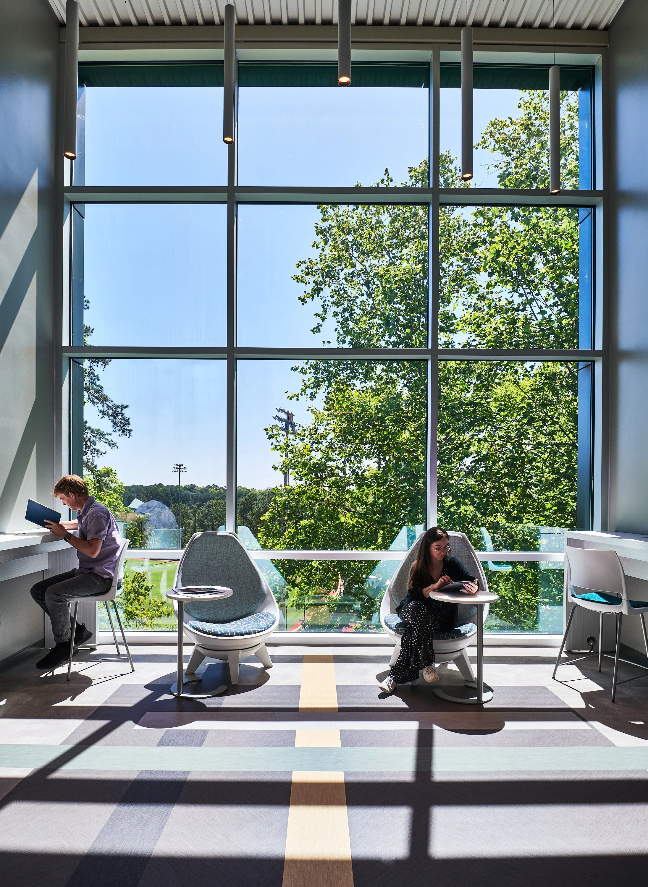 Interior break out space at the end of a corridor for students with the backdrop of Kawneer curtainwall glazing -project by B Group Architecture, Inc.
