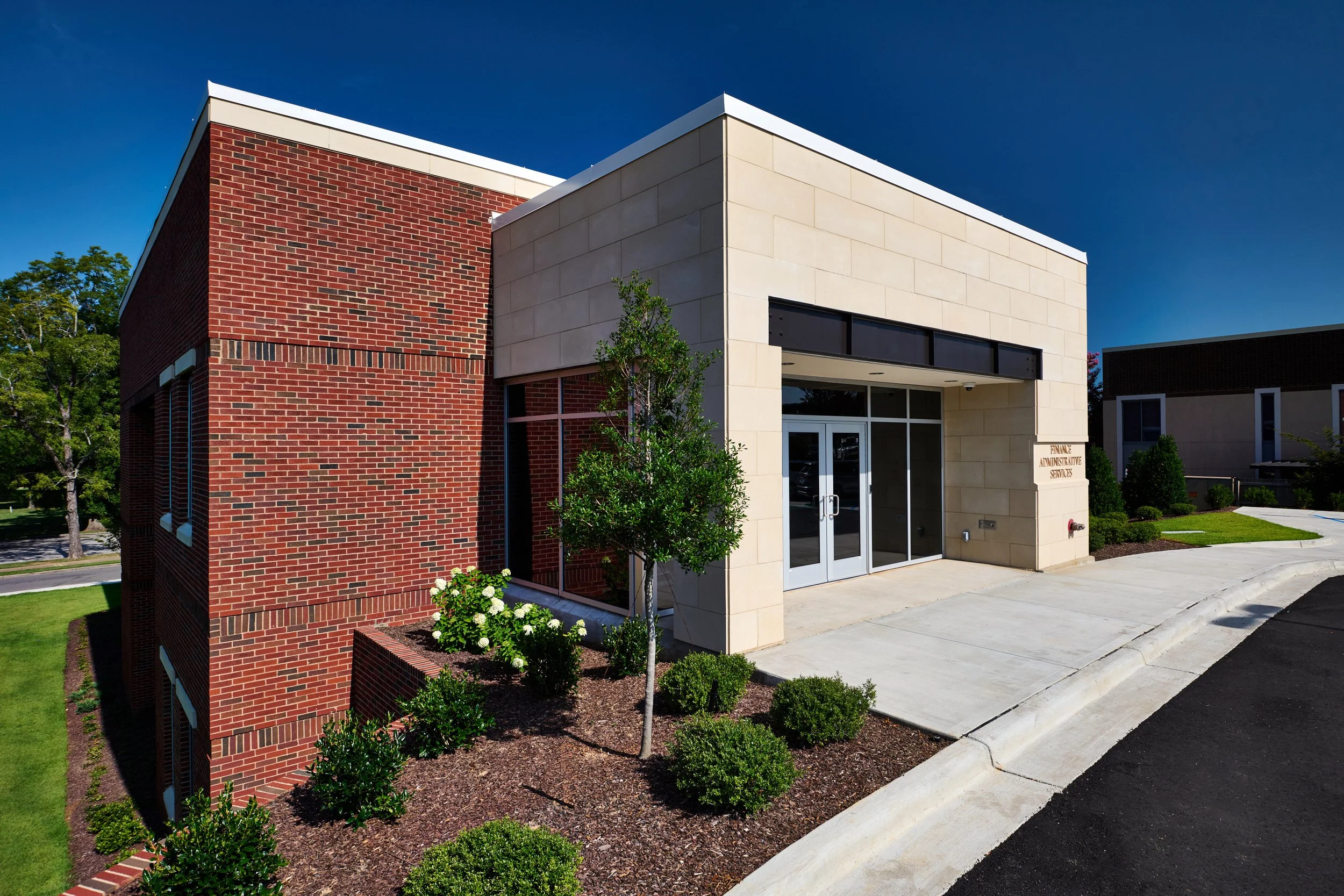 Renovation of the University of Alabama Administration Building. The exterior entrance constructed from cast stone and glazing -project by B Group Architecture, Inc.