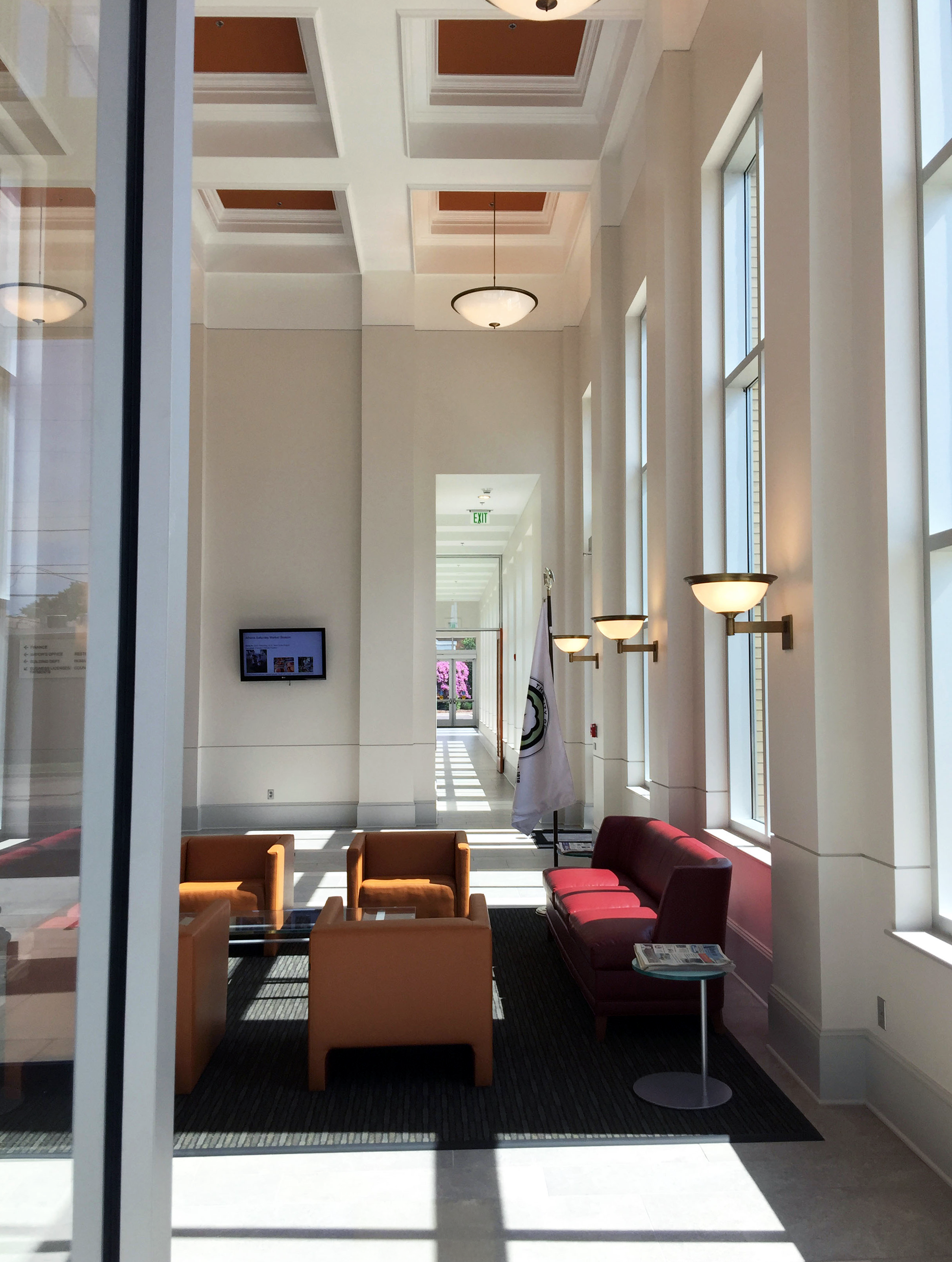An interior view of the lobby of Athens City Hall with soaring vaulted ceilings and an incredible amount of natural lights.- project by B Group Architecture, Inc.