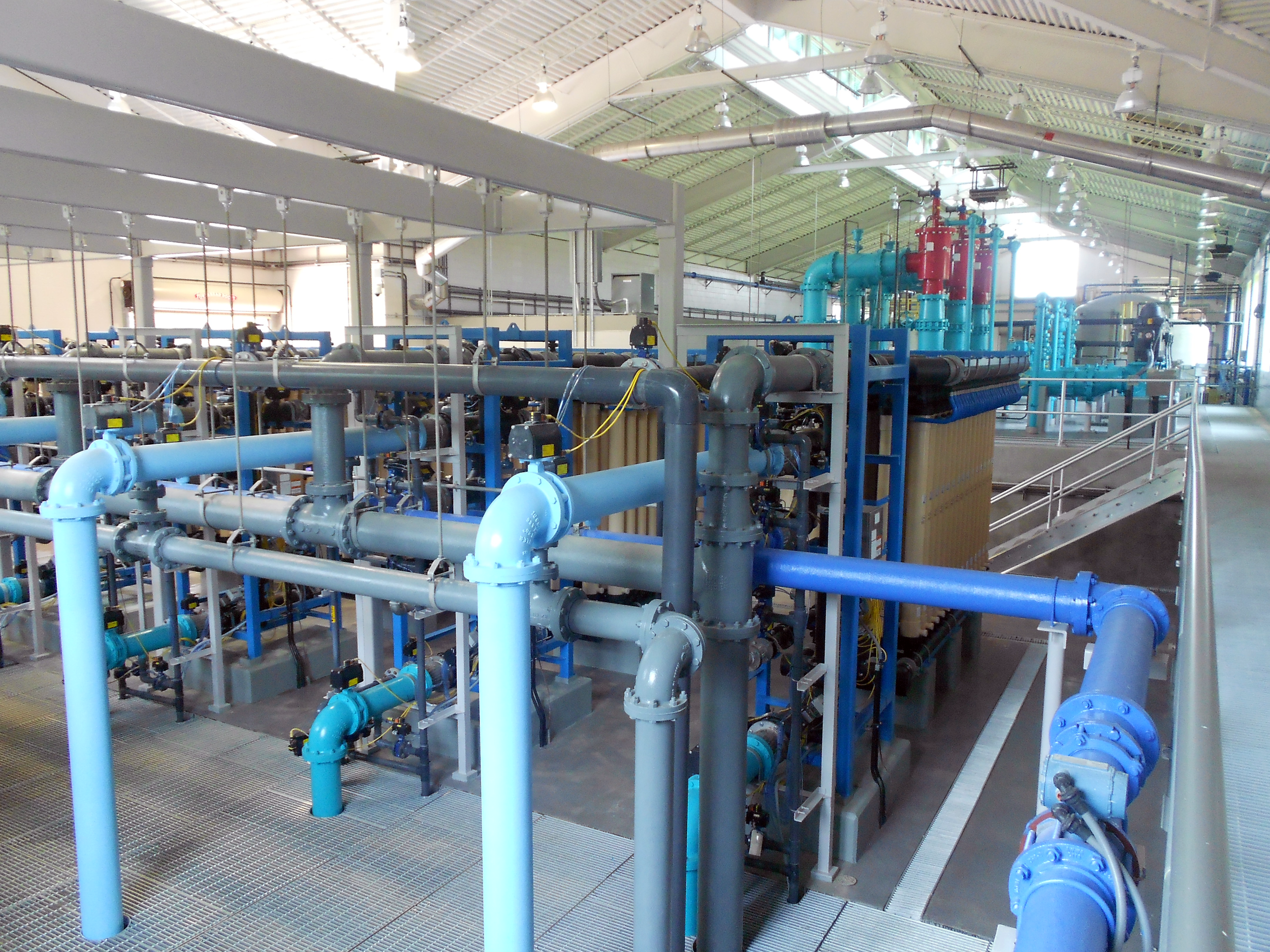 Industrial water filtration system with multiple inside a spacious, well-lit facility at Ft. Benning Water Treatment Plant - project by B Group Architecture, Inc.