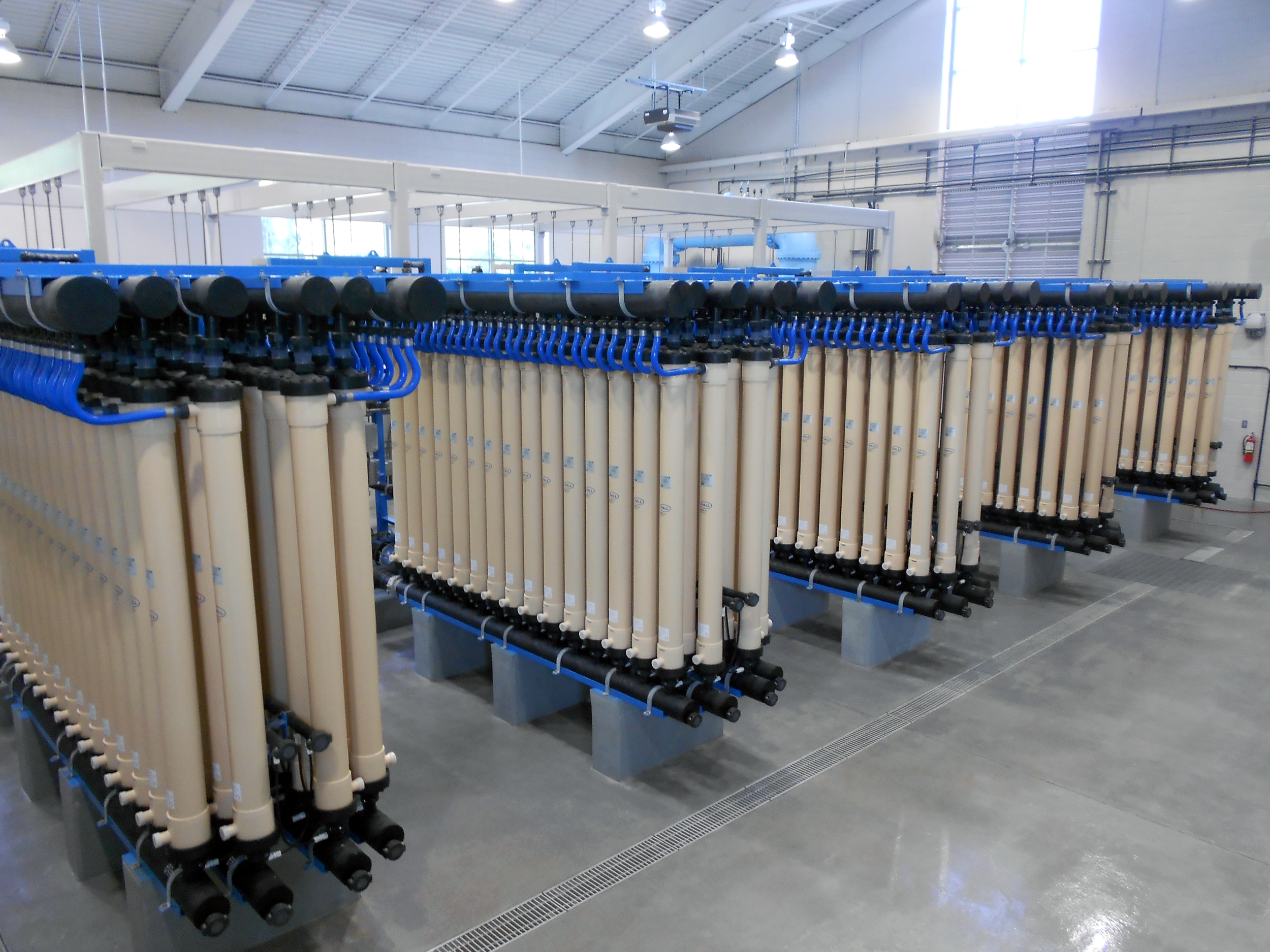 Industrial water filtration system with multiple inside a spacious, well-lit facility at Ft. Benning Water Treatment Plant - project by B Group Architecture, Inc.