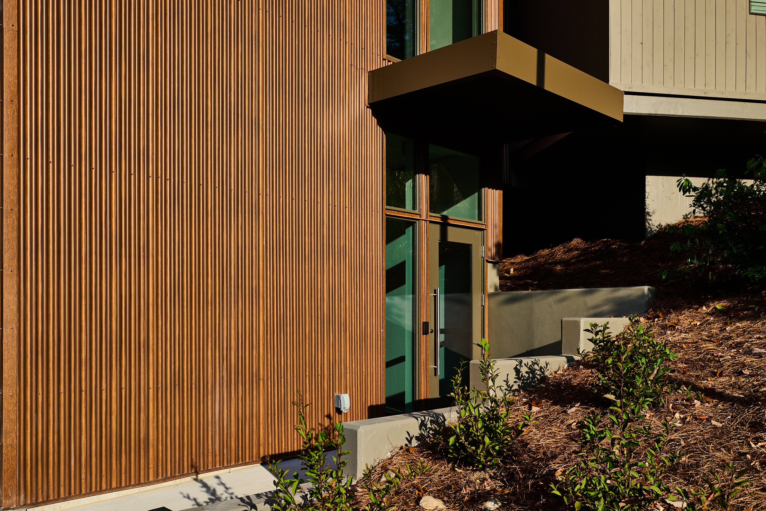 A renovation of an existing multi-story building at Vulcan Place in Birmingham, AL nestled in the woods. A new stair tower was added in a corten metal. project by B Group Architecture, Inc.