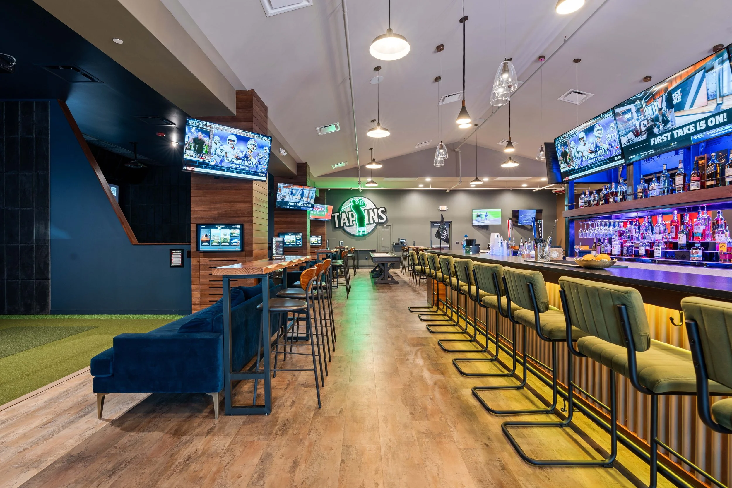 Tap Ins blends the excitement of a sports bar with the energy of an upscale game lounge . project by B Group Architecture, Inc
