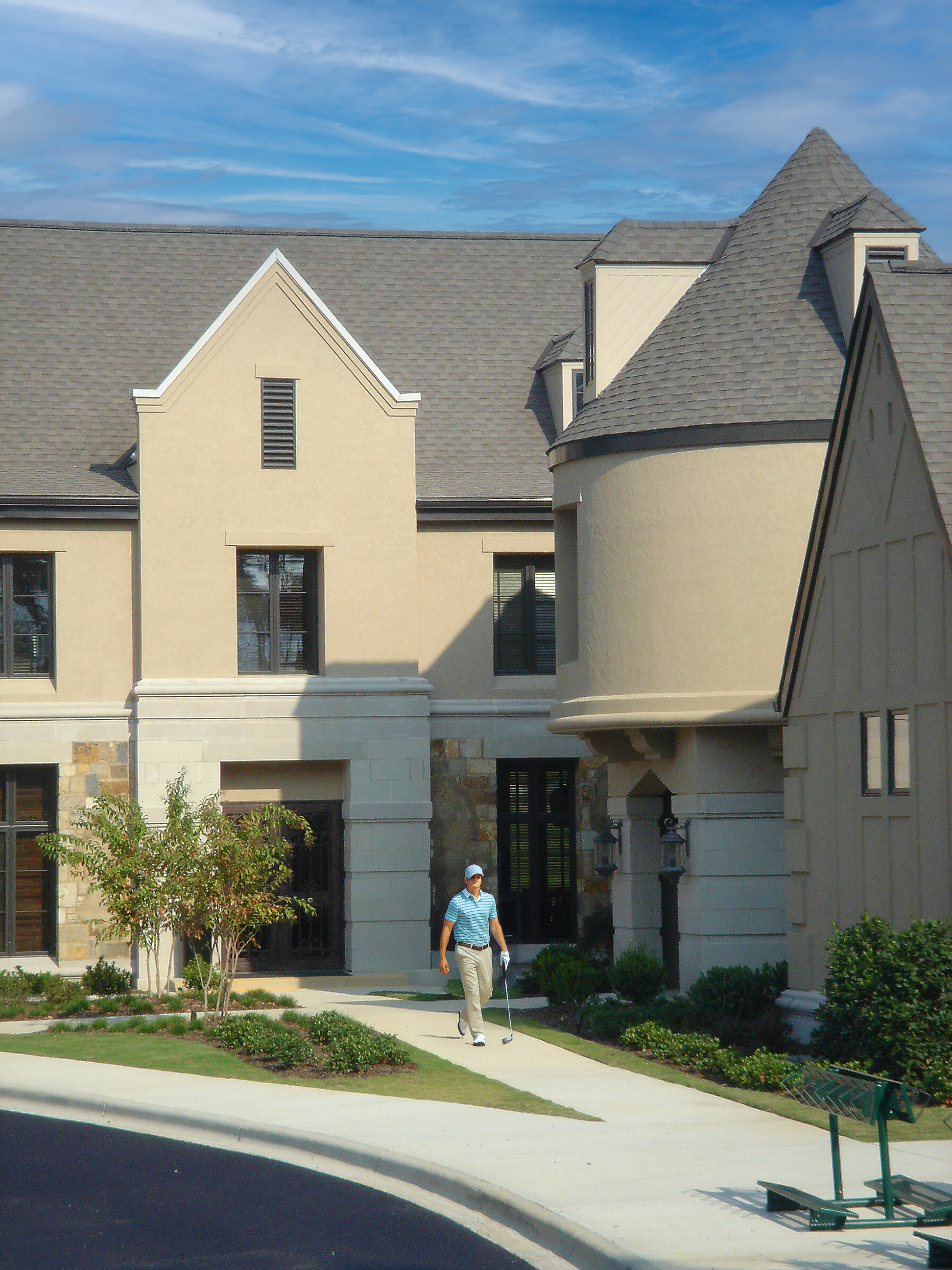 Ballantrae Golf Club exterior entrance with stone and stucco exterior and curved turrets. project by B Group Architecture Inc. 