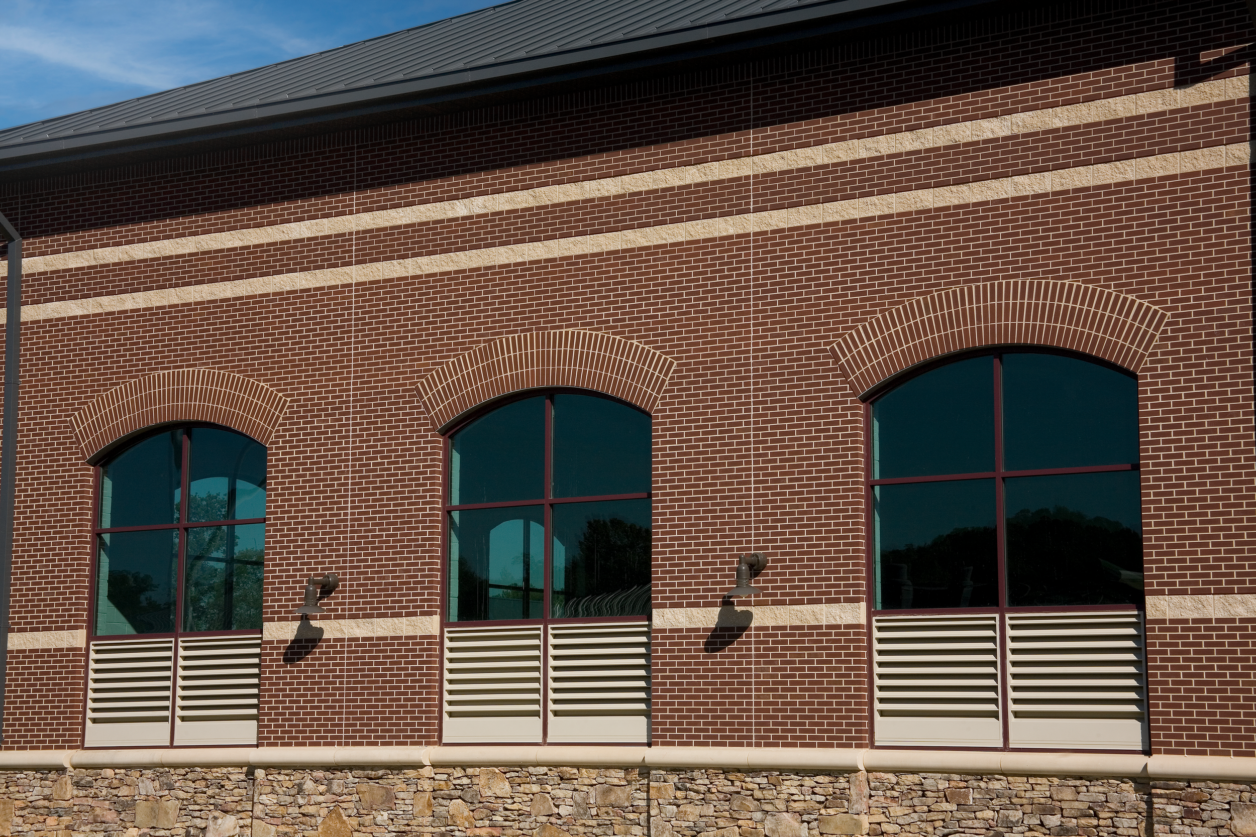 Modern building with two tone brick and storefront glass at Turkey Creek Wastewater Treatment Plant - project by B Group Architecture, Inc.