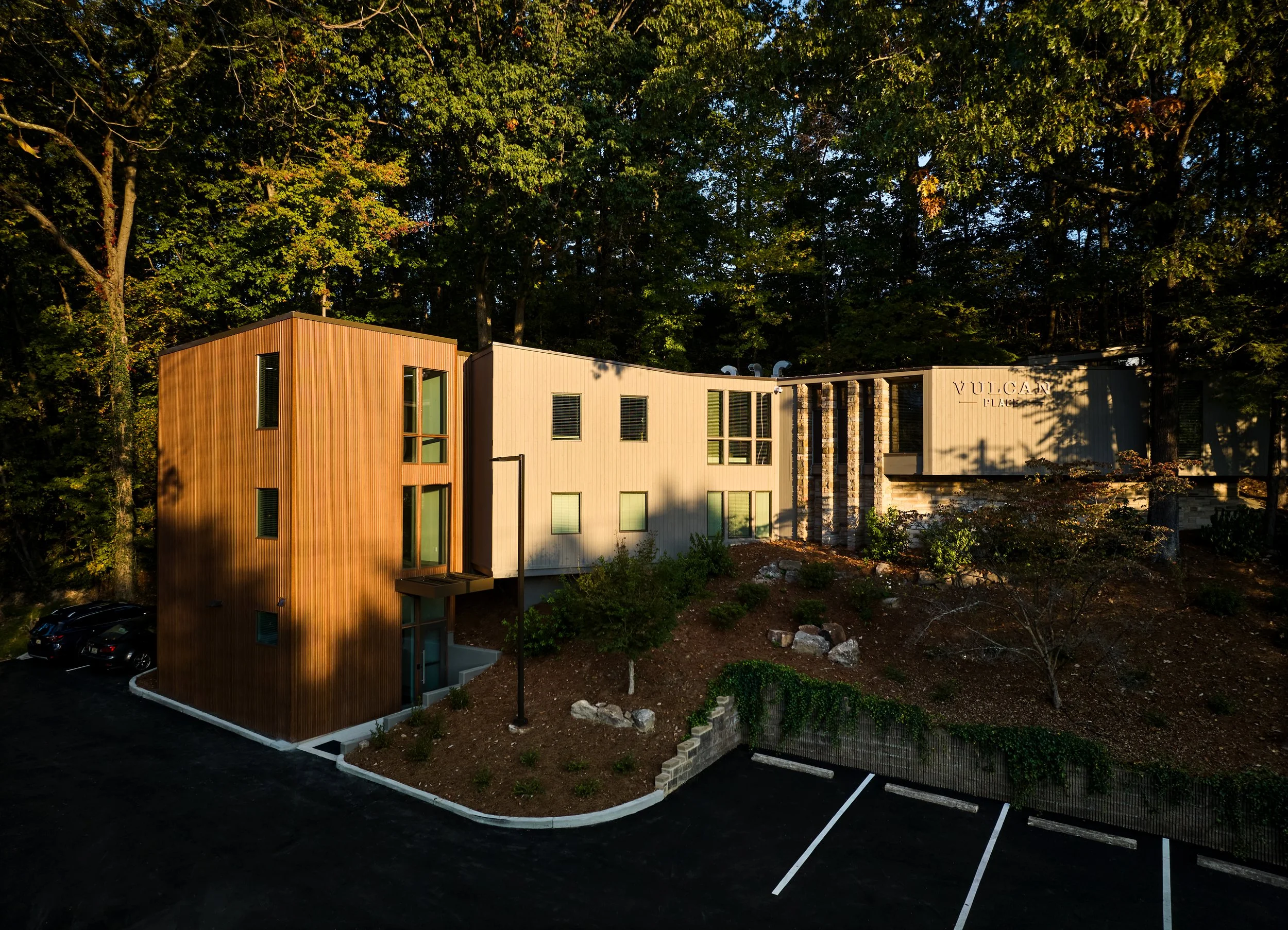 A renovation of an existing multi-story building at Vulcan Place in Birmingham, AL nestled in the woods. A new stair tower was added in a corten metal and new punched openings in the existing facade. project by B Group Architecture, Inc.