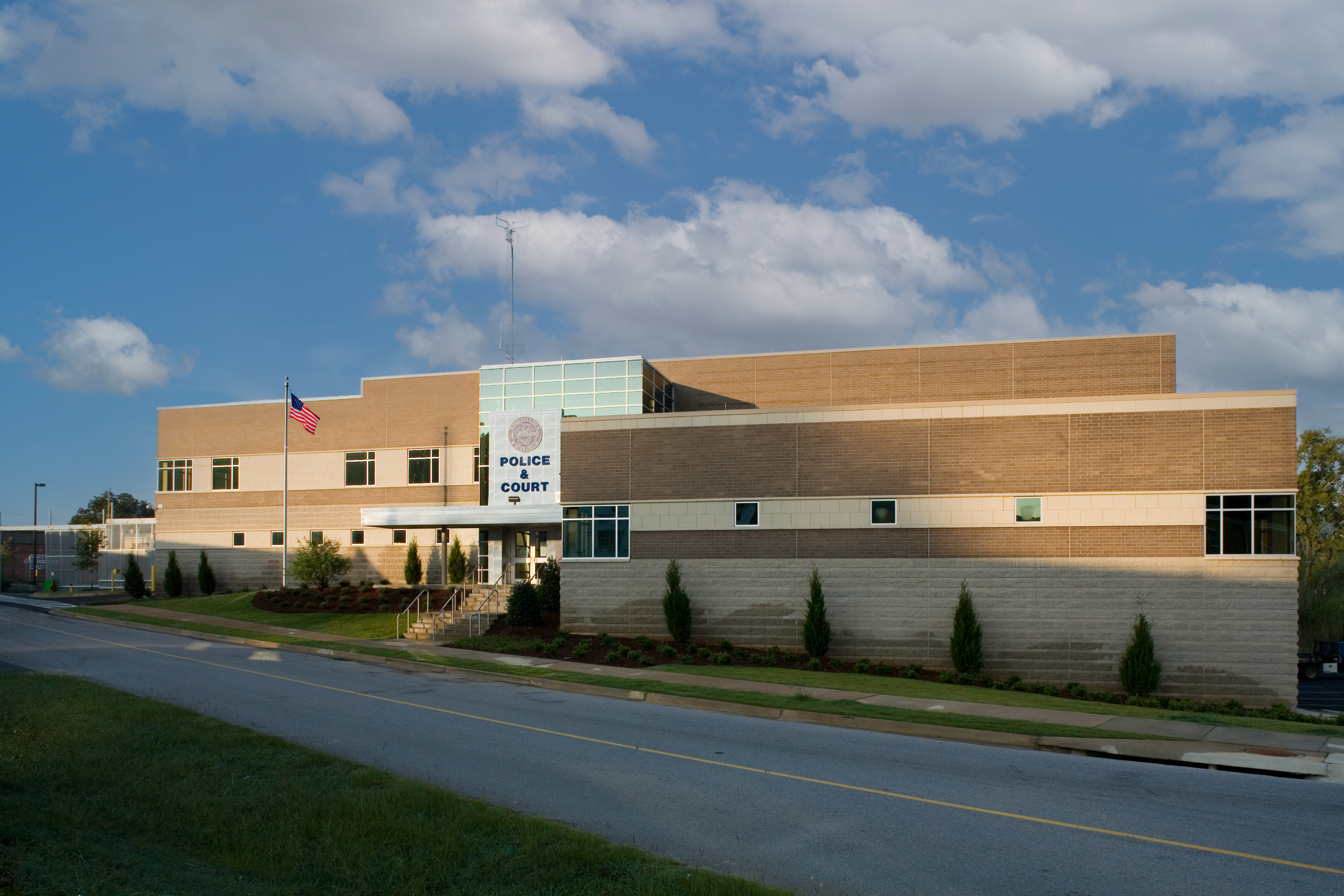 Pelham, AL Police Department's modern building clad in glass, metal panels, brick and cast stone trim. project by B Group Architecture Inc.