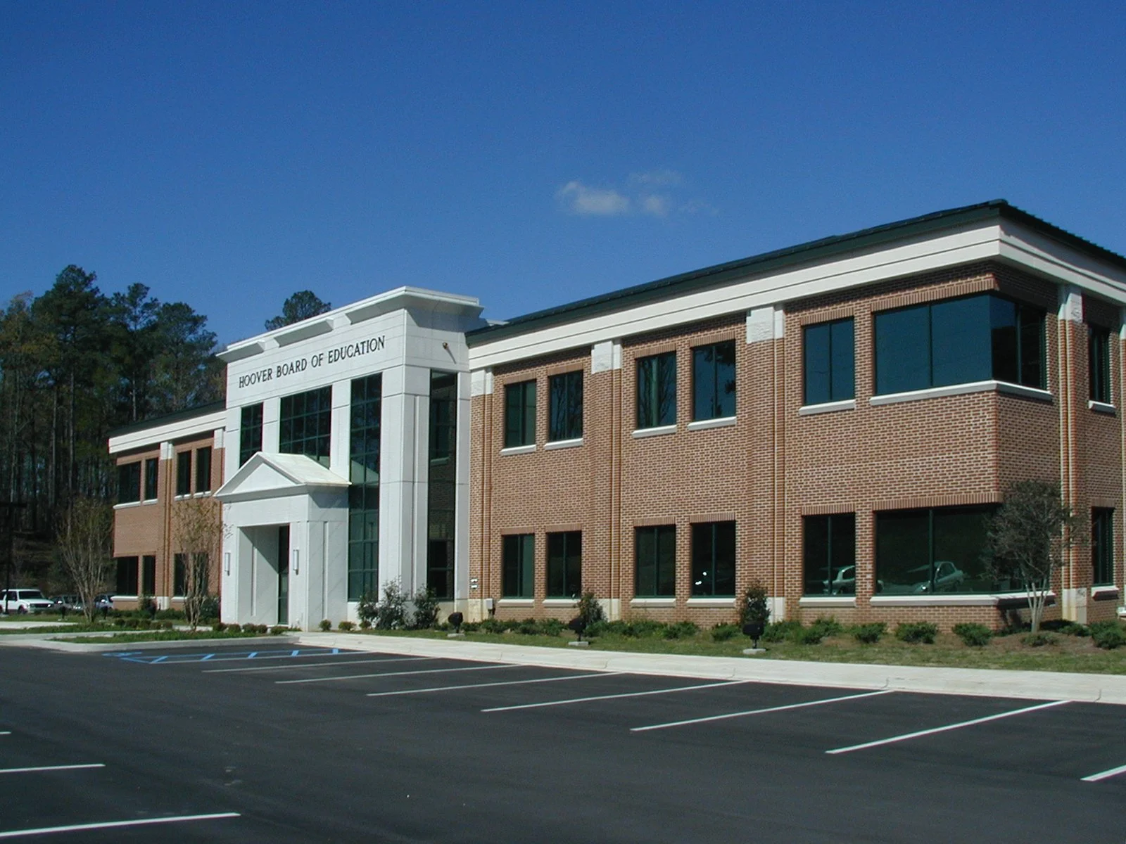 Hoover Board of Education with stone entry facade, large glass windows, and brick and cast stone. project by B Group Architecture, Inc.