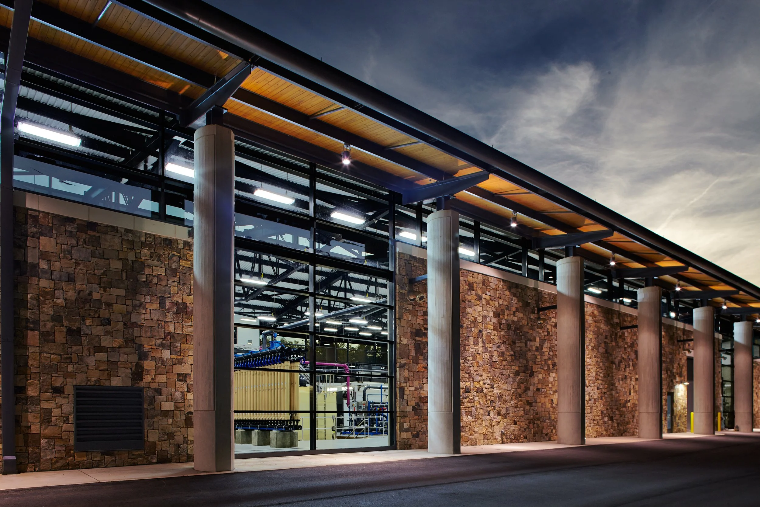 W.A Warner Williams Water treatment plant's LEED accredited modern building complex with illuminated windows.  -project by B Group Architecture,  Inc.