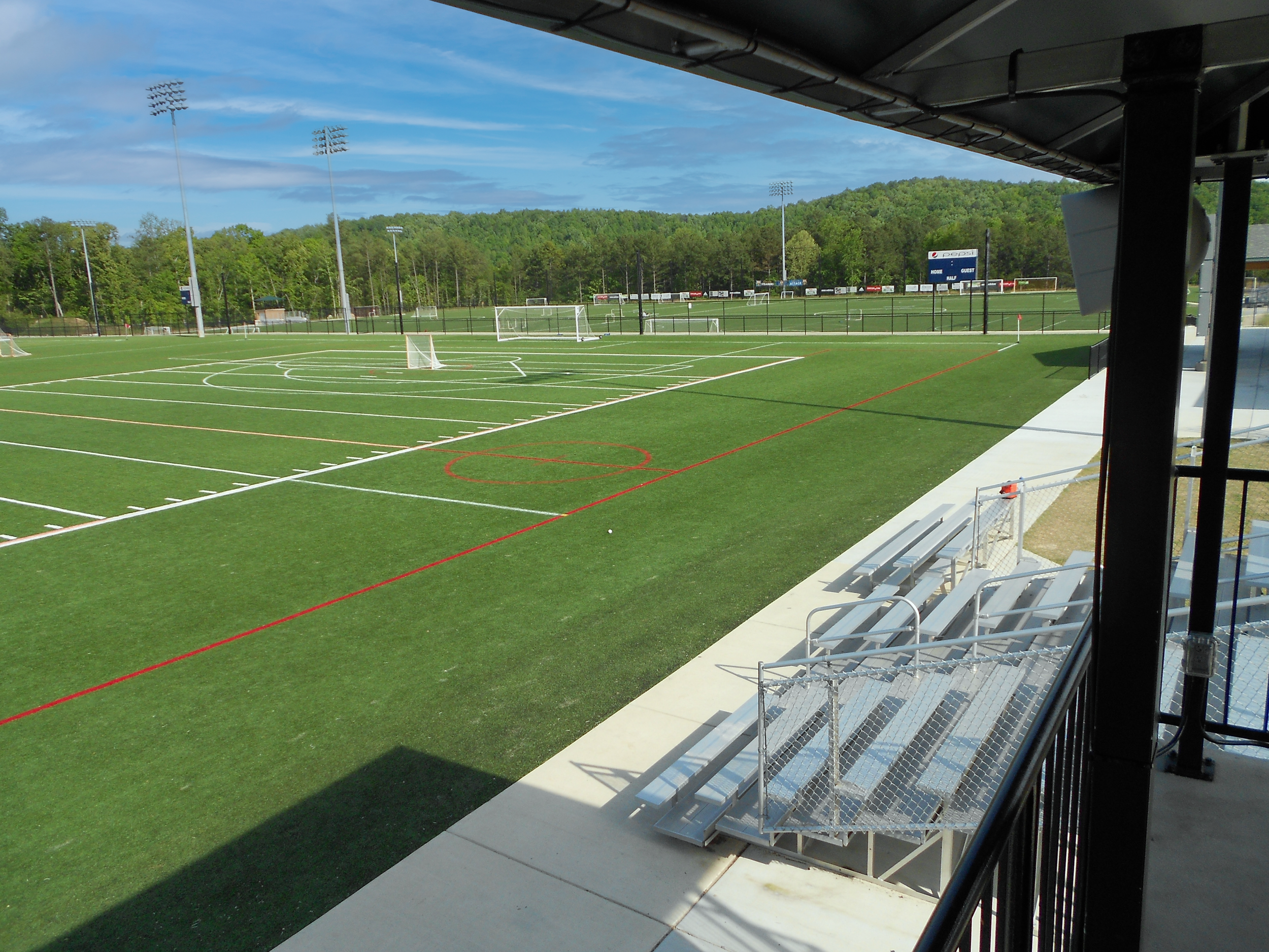 View of the bleachers and soccer fields at the Vestavia Sports Park project by B Group Architecture, Inc.