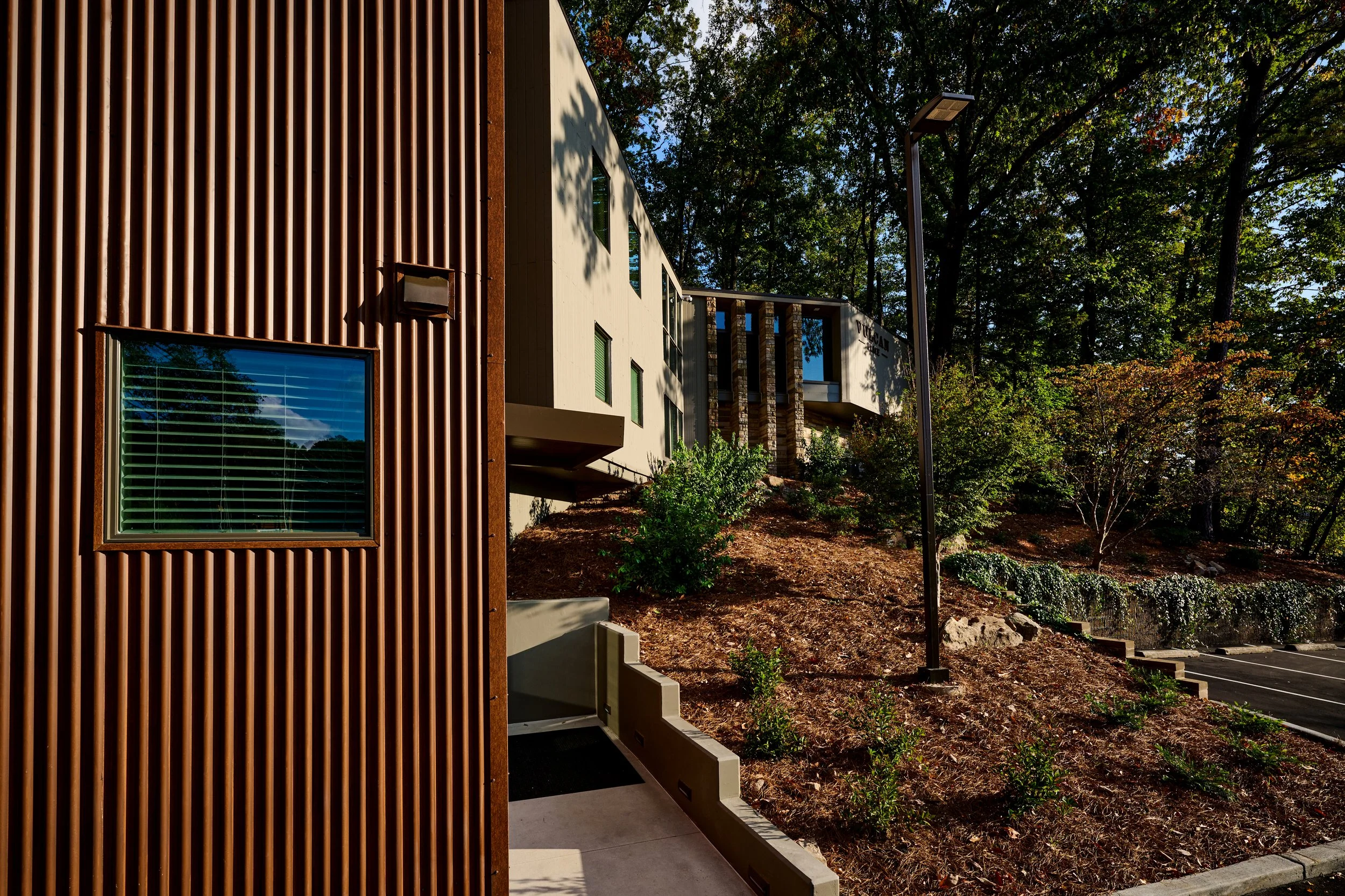 A renovation of an existing multi-story building at Vulcan Place in Birmingham, AL nestled in the woods. A new stair tower was added in a corten metal. project by B Group Architecture, Inc.