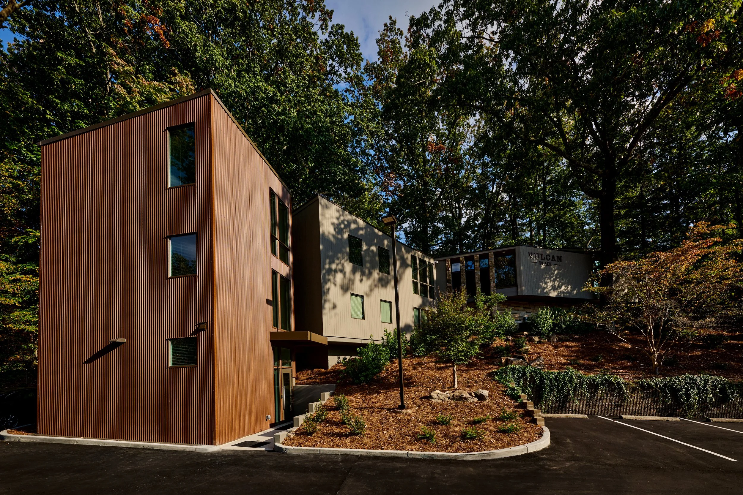 A renovation of an existing multi-story building at Vulcan Place in Birmingham, AL nestled in the woods. A new stair tower was added in a corten metal. project by B Group Architecture, Inc.