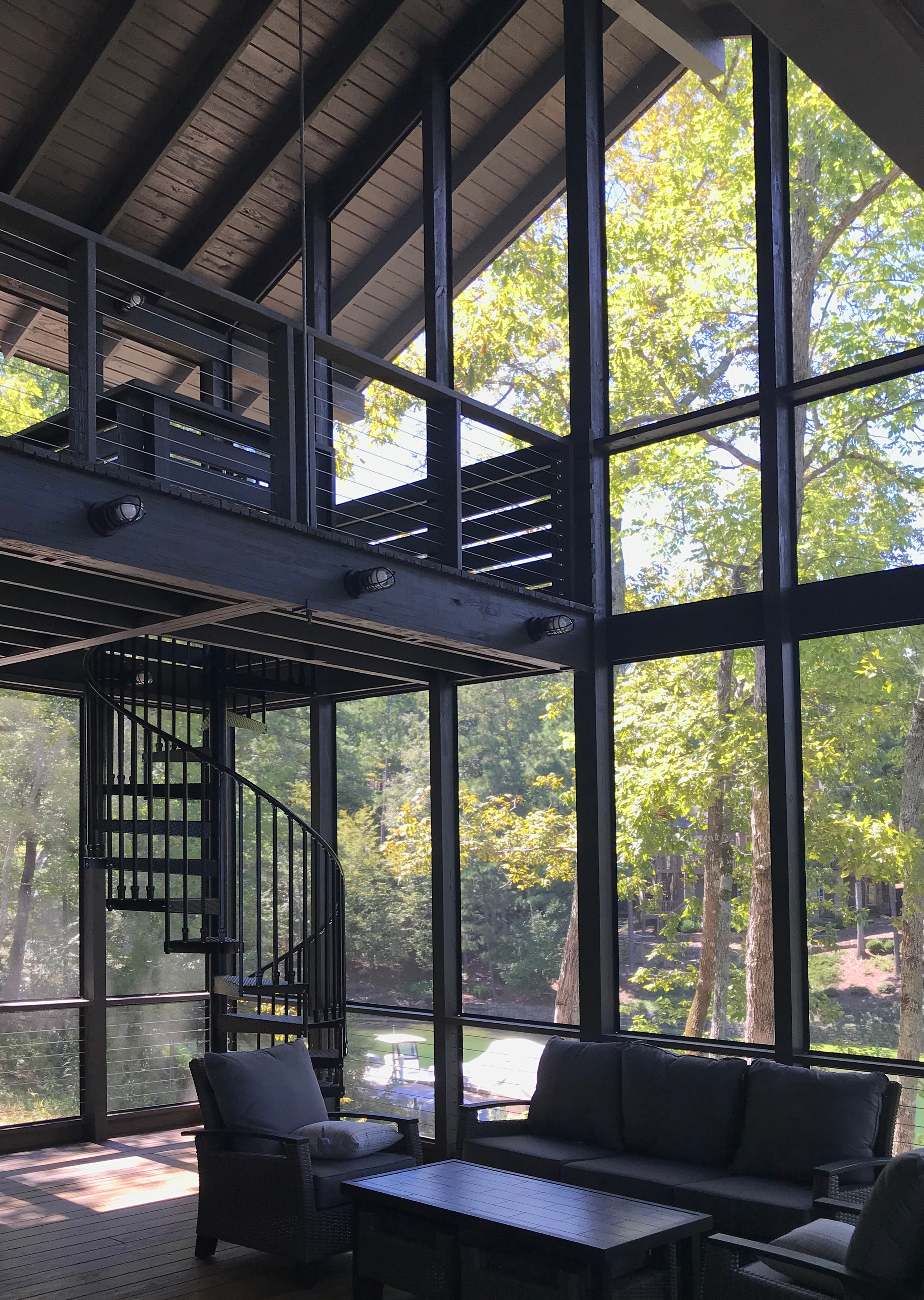 A screened porch at a lake house in Pelham, AL. taking advantage of increasing views of the natural landscape. project by B Group Architecture, Inc.