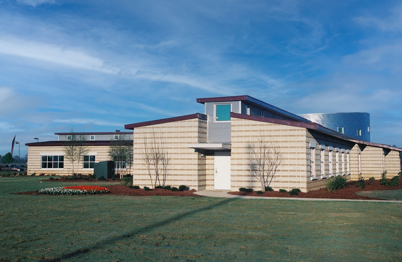 Modern building with brick and metal exterior and several windows.