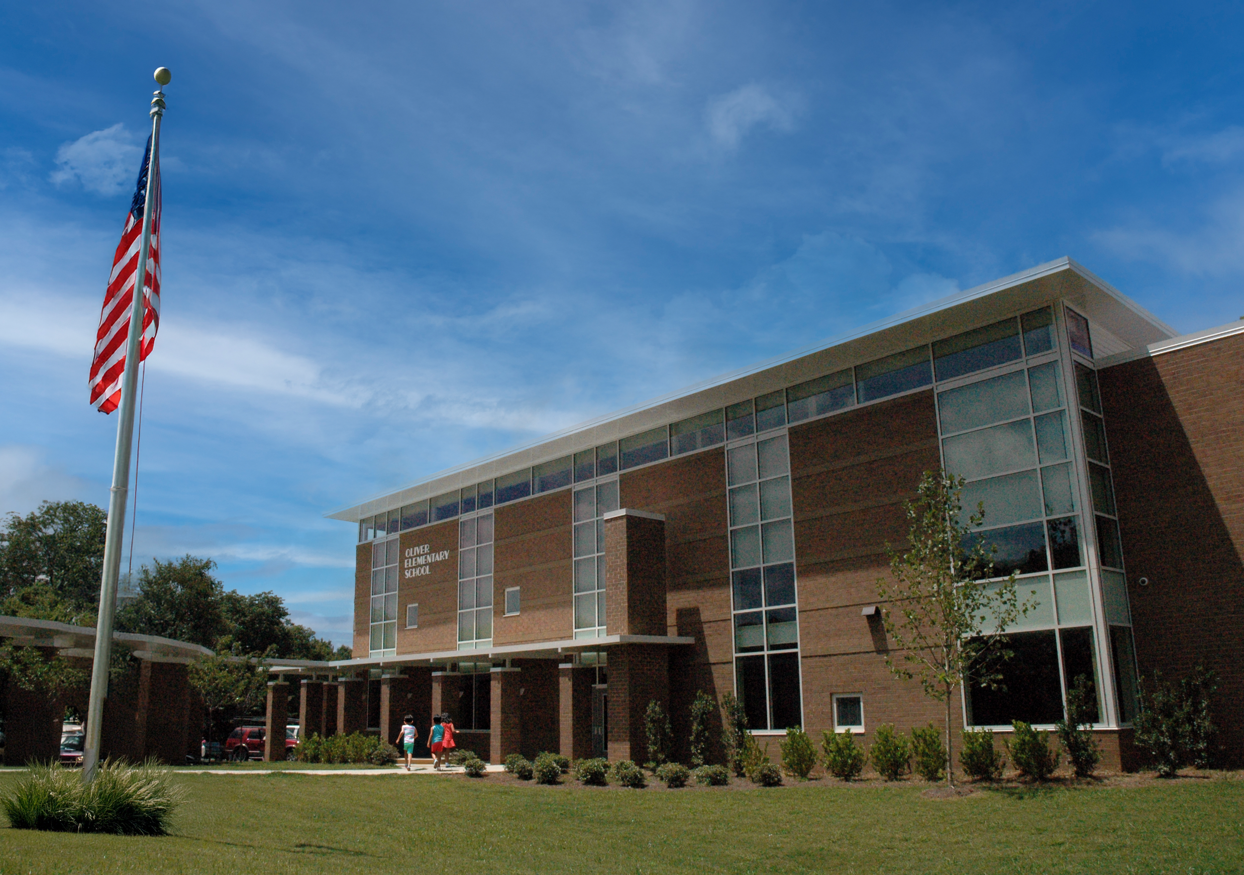 Front view of Oliver Elementary School with large glass window walls,  with a modern brick .  - project by B Group Architecture, Inc.