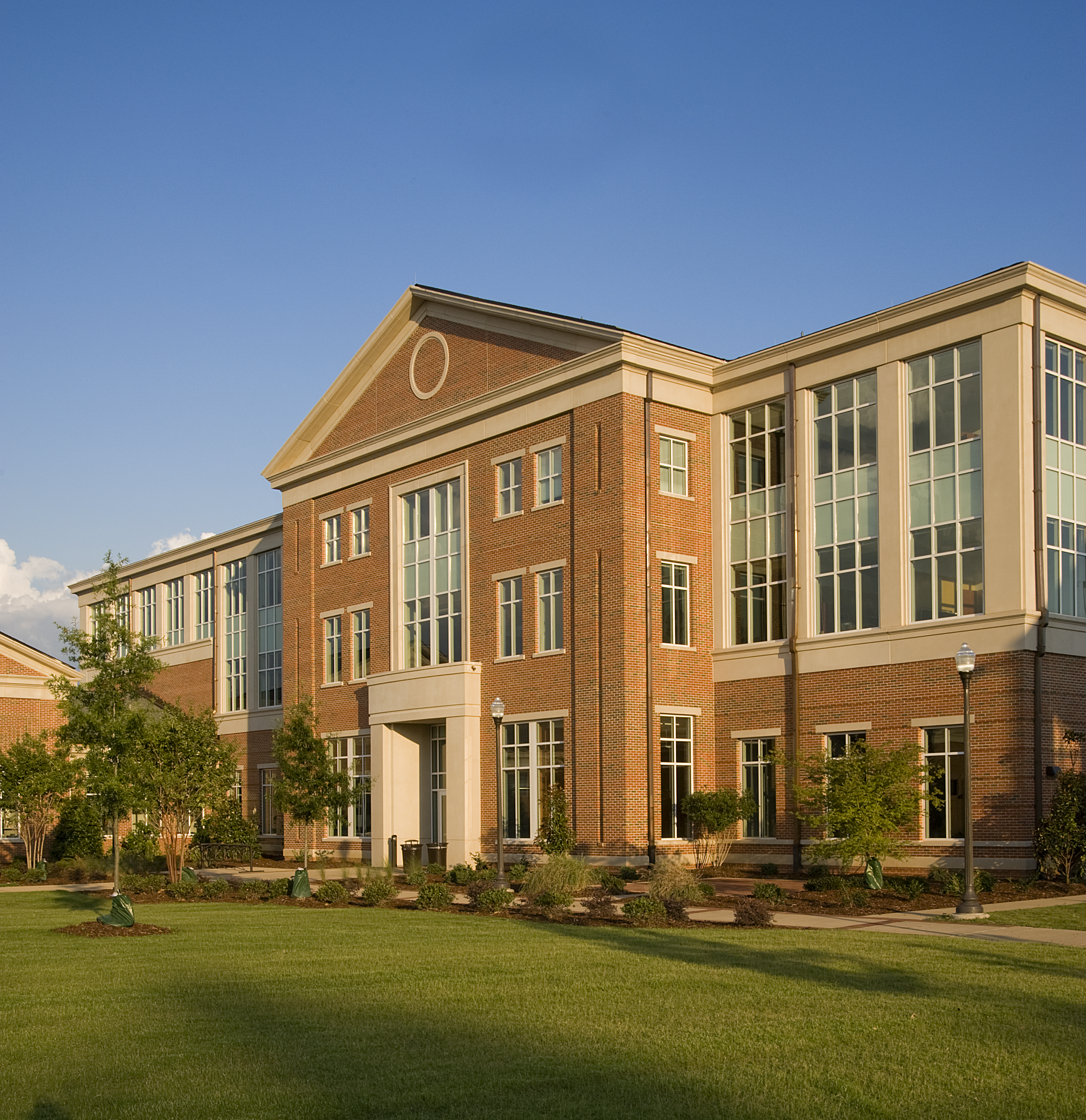 Entrance for the Auburn University's Office for Information. Brick and cast stone building  with three floors, large windows, emphasizing Georgian style design principles that integrate with the campus fabric. - project by B Group Architecture, Inc.