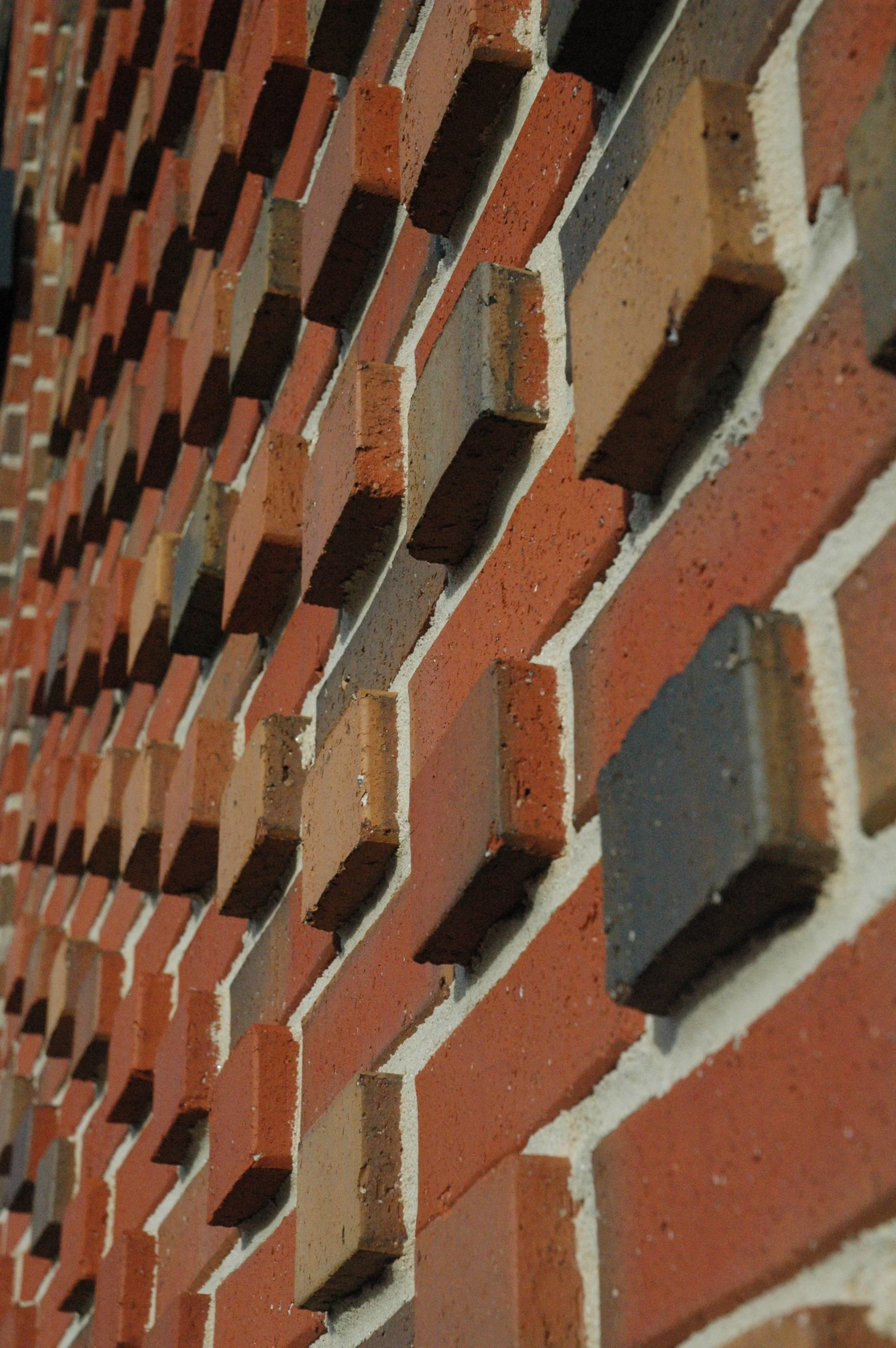 Close-up of a brick wall with interesting undulating brick pattern. project by B Group Architecture, Inc.