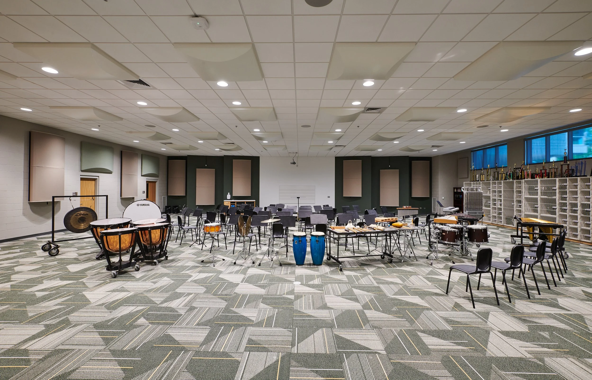 A music rehearsal room with custom instrument storage and acoustical treatments- project by B Group Architecture, Inc.