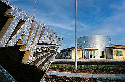 Exterior of a modern building with a sign reading 'Talledega Super Speedway'. project  by B Group Architecture, Inc. 