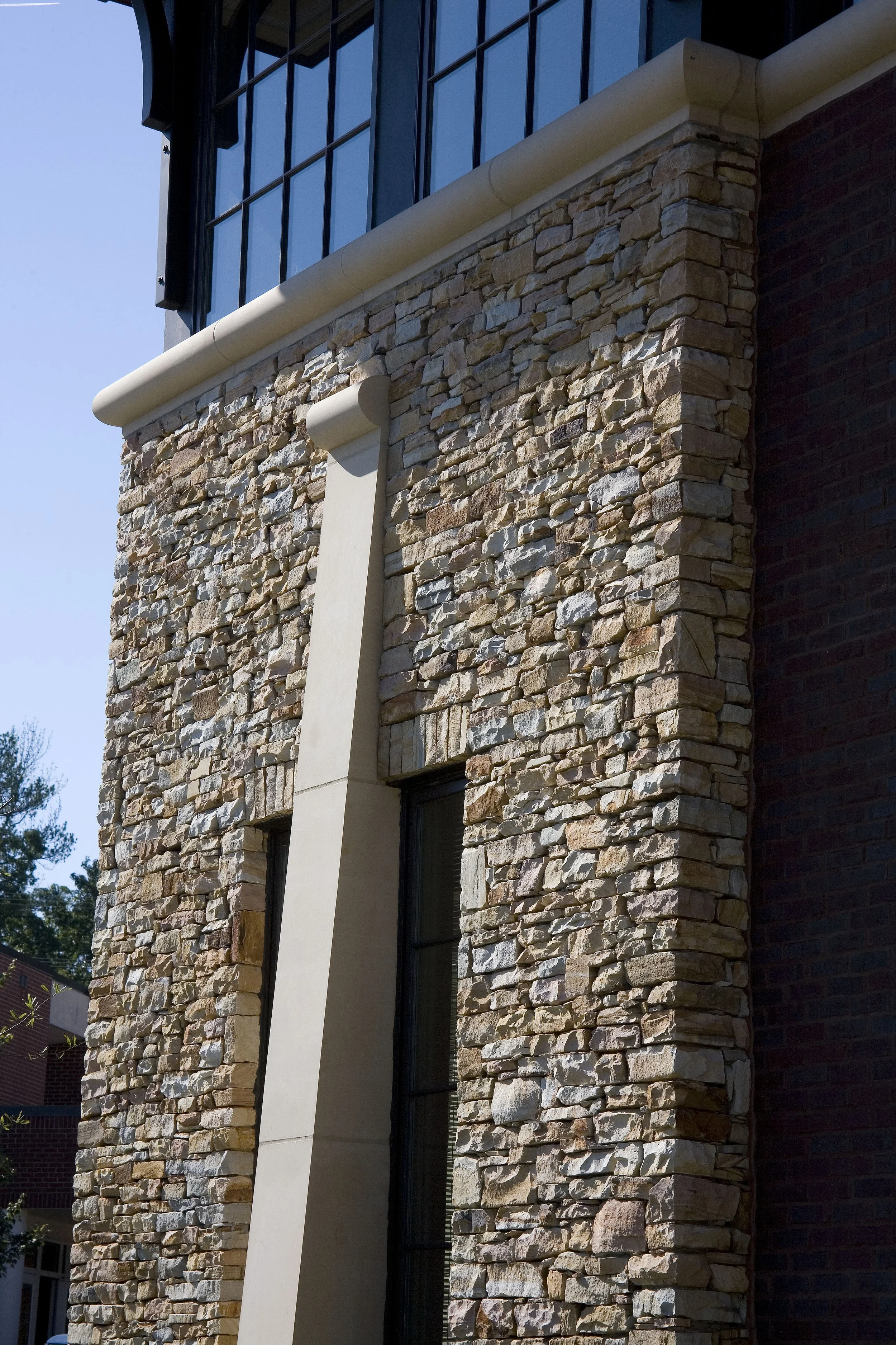 Exterior view of Mountain Brook Board Of Education. The cast stone trim accentuates the natural stone on the facade .  project by B Group Architecture, Inc.