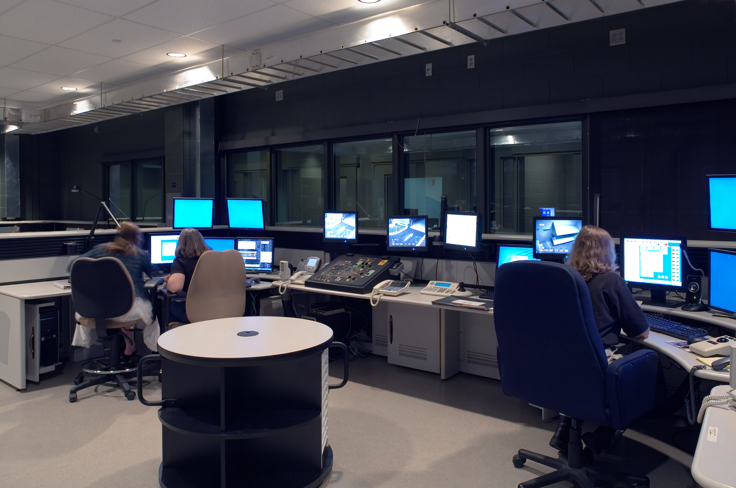 Pelham, AL Police Department's control room with multiple monitors, computers. project by B Group Architecture Inc.