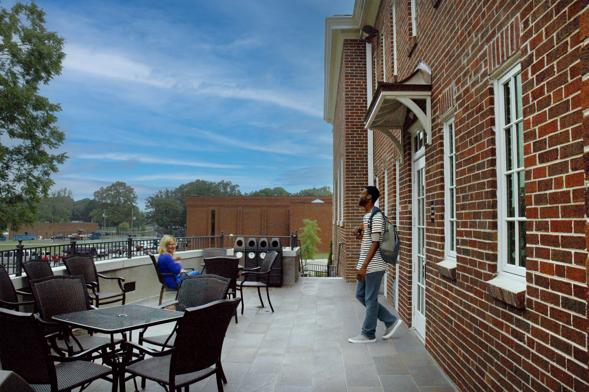 Norton library renovation has traditional red brick and cast stone trim, large windows, and an outdoor lounge space set on a Snead State college campus. - project by B Group Architecture, Inc.