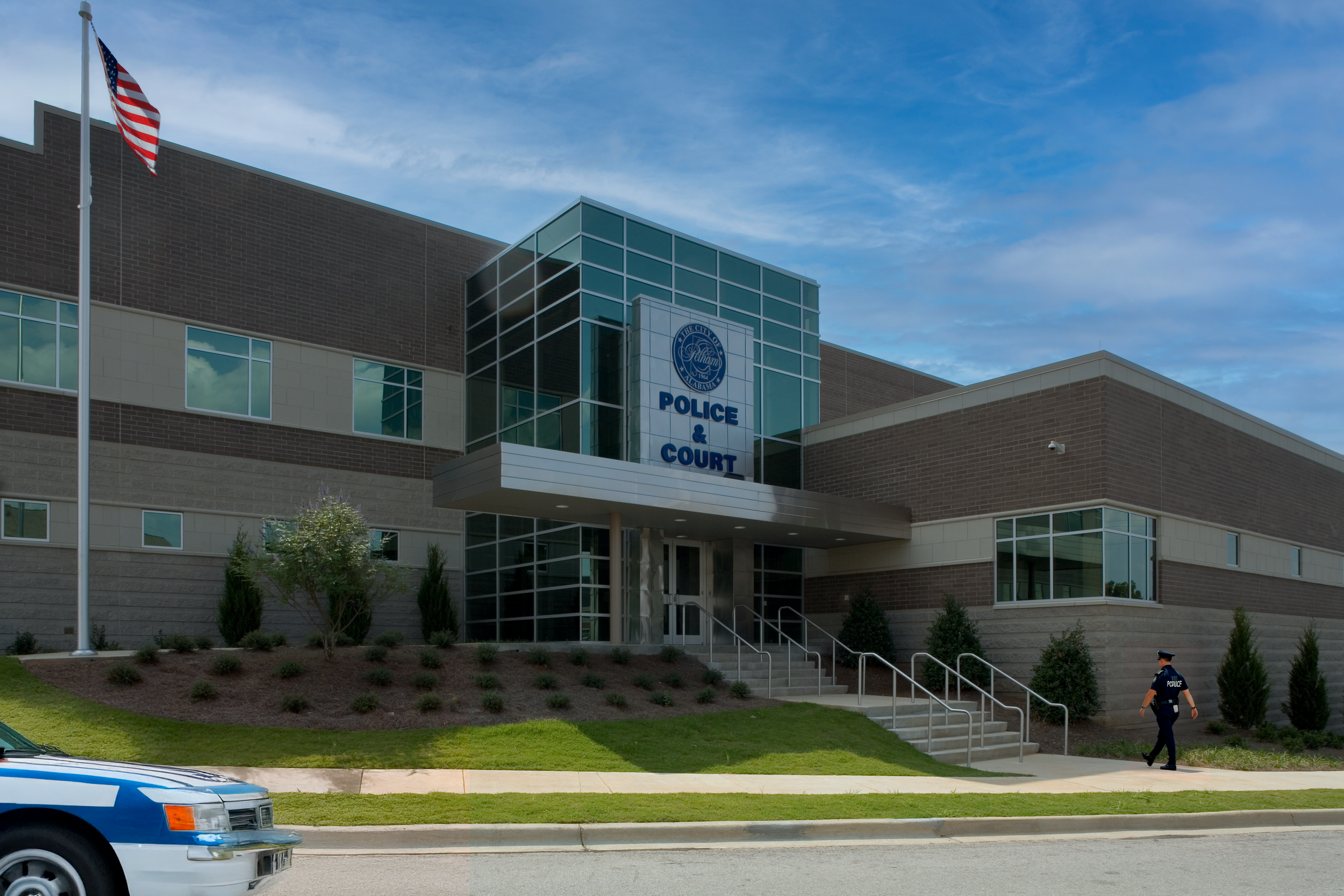Pelham, AL Police Department's modern building clad in glass, metal panels, brick and cast stone trim. project by B Group Architecture Inc.