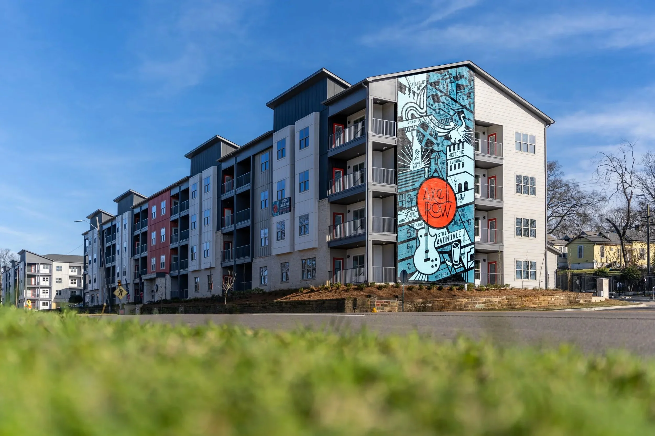 Axel Row Birmingham AL. New, modern apartments offering the latest features and contemporary finishes within one of Birmingham’s most historic neighborhoods–Avondale. Showcasing a 4 story mural on the exterior facade - project by B Group Architecture