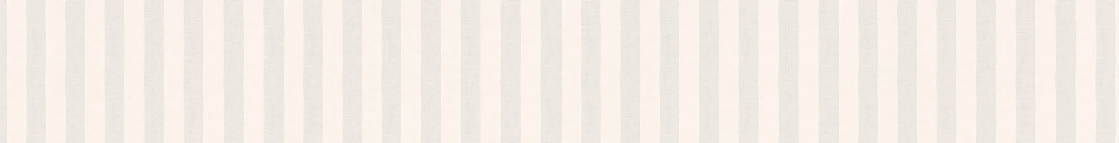 A light-colored wall with vertical beige and white stripes.