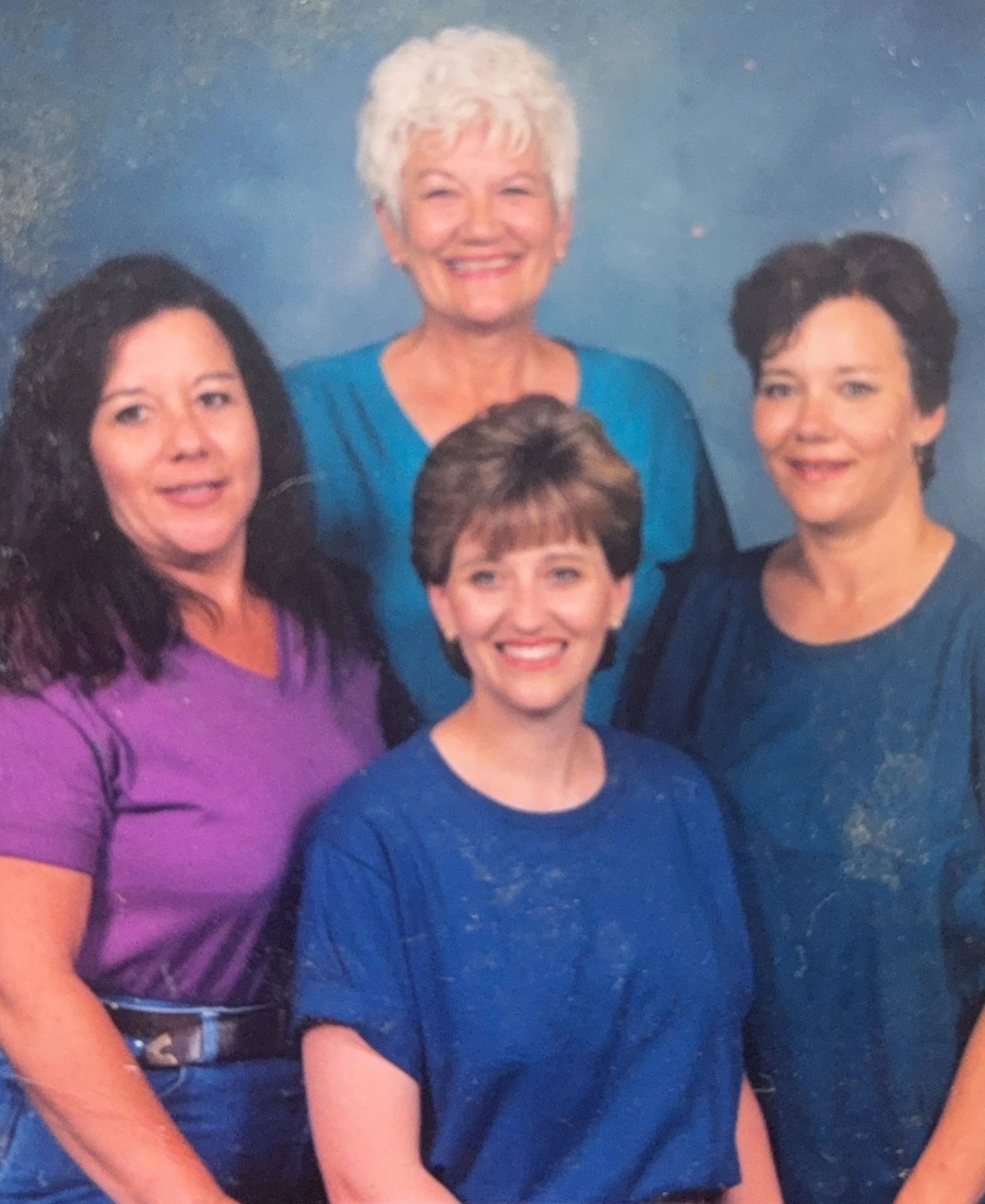 Cali and three women posing for a photo.