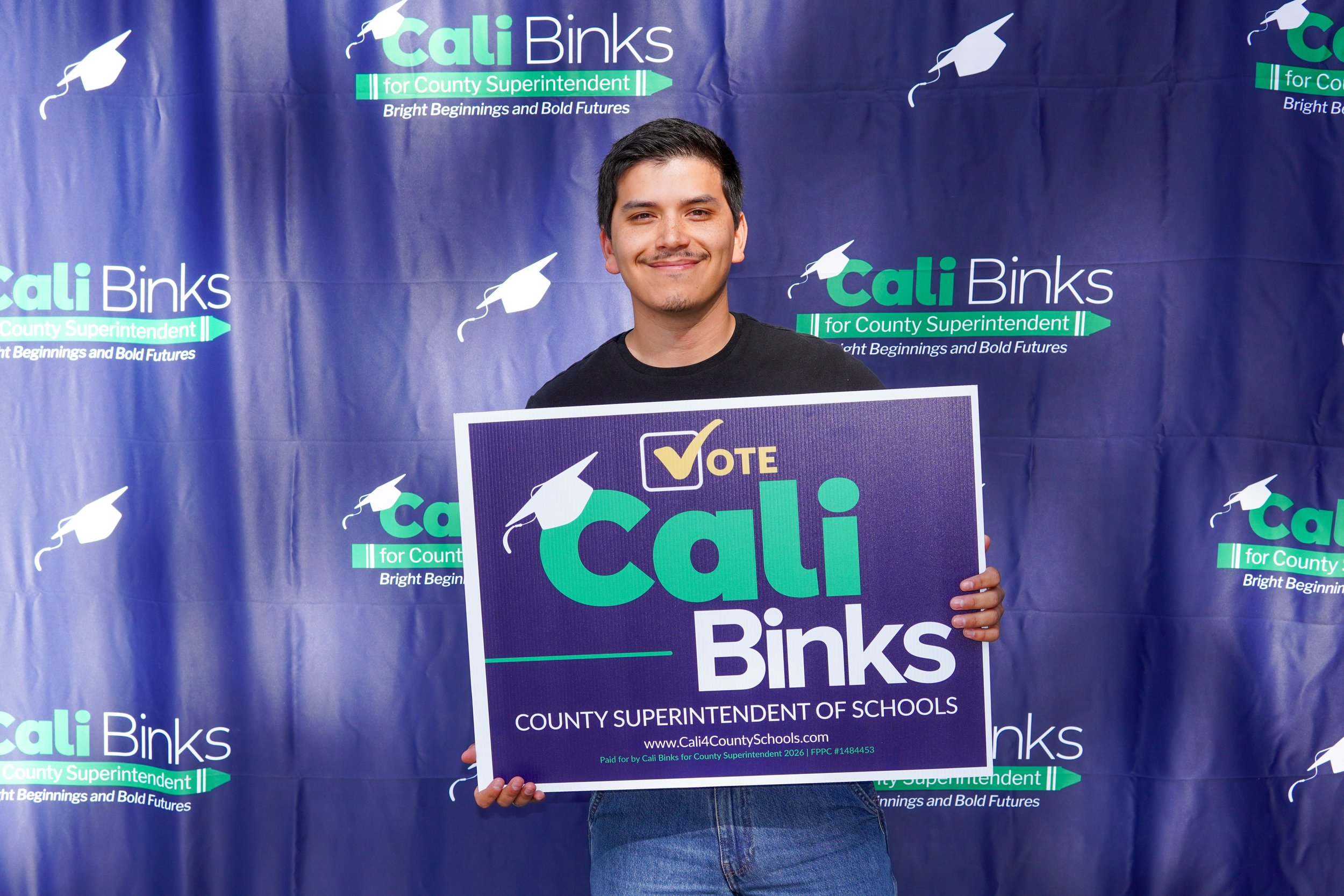 Adult holding a yard sign.