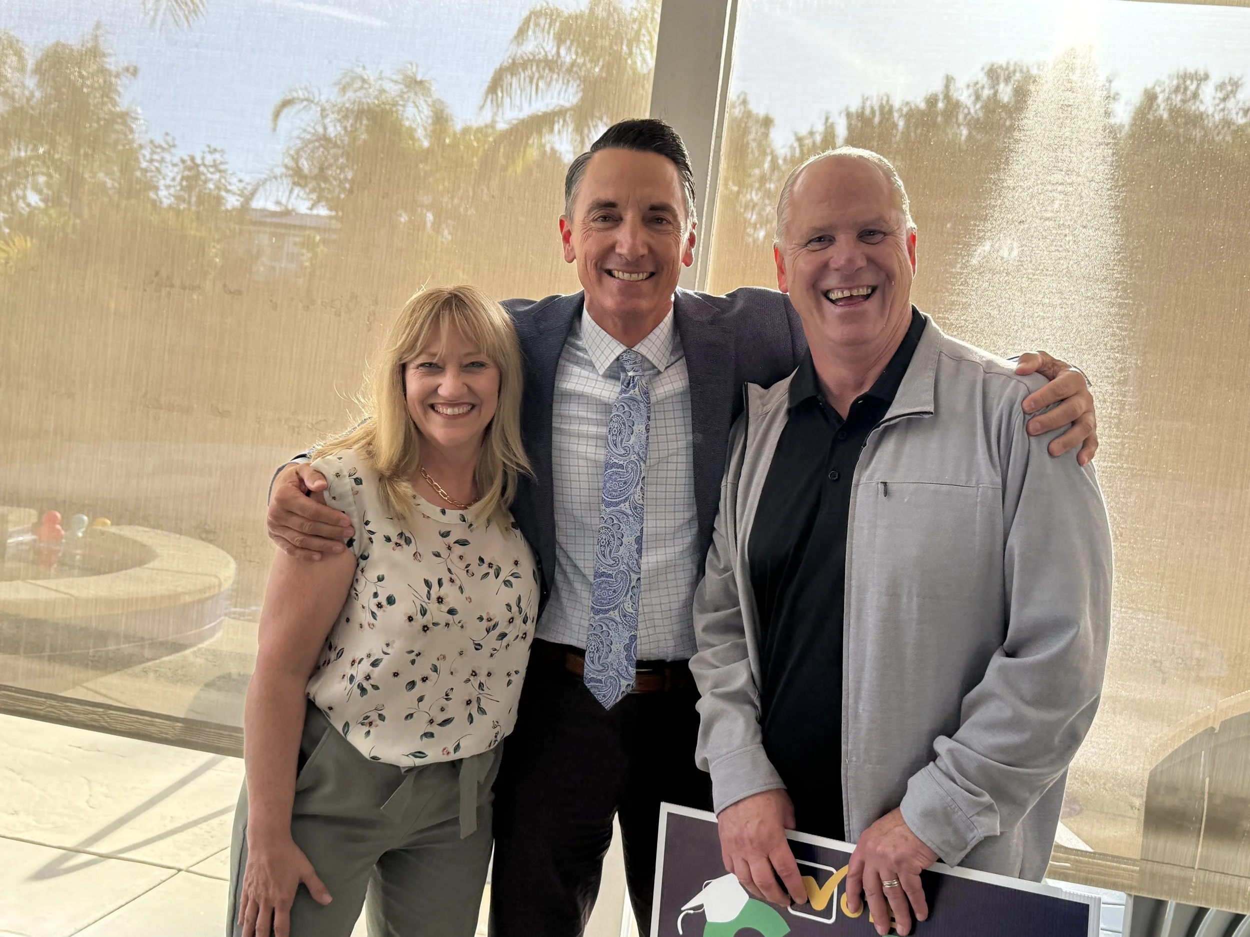 Two adults posing for a photo with Cali