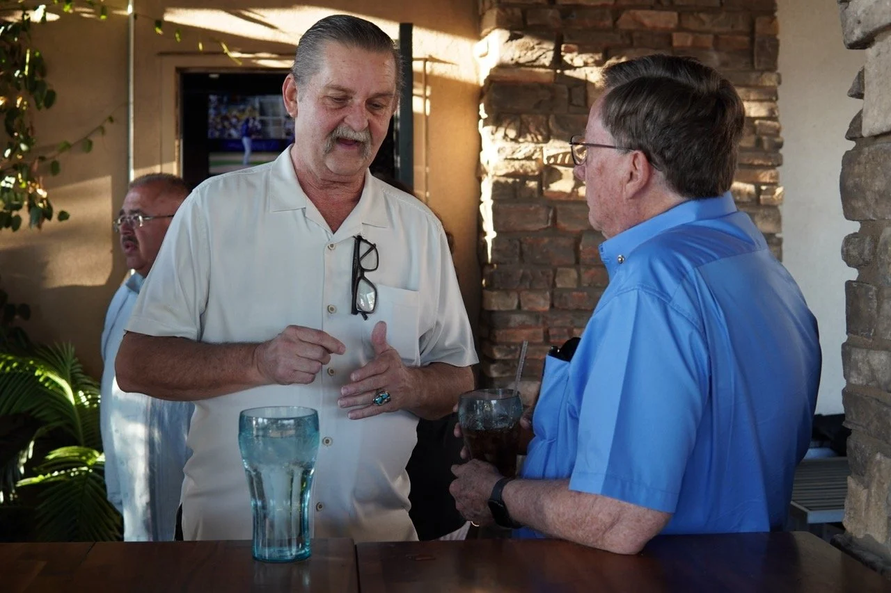 Michael Tulisiak, retired SEBA officer speaking to a guest.