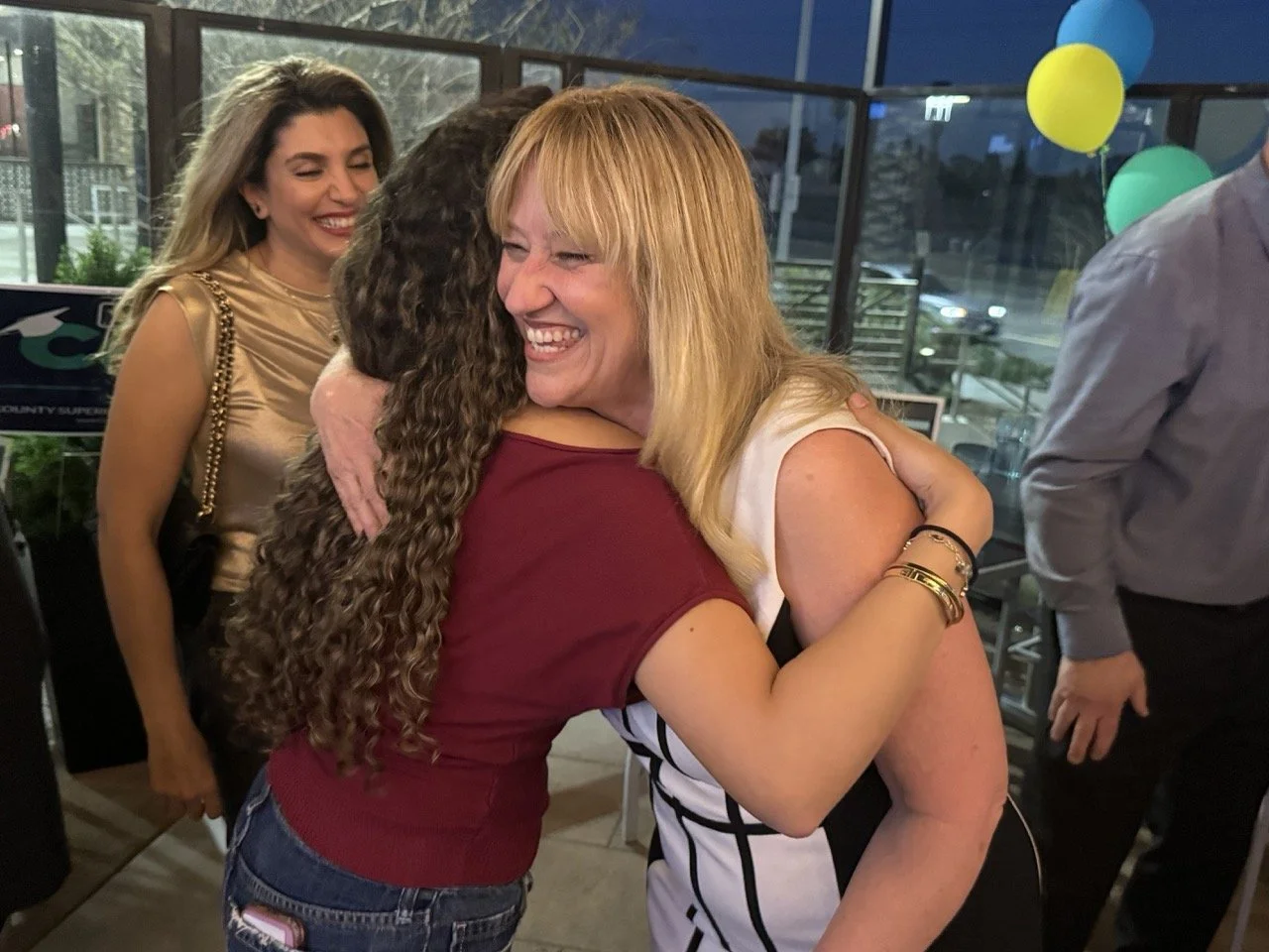 Cali hugging former student from Los Osos High School.