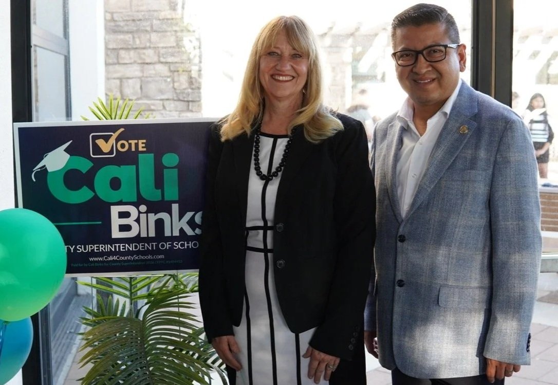 Second District County Supervisor Jesse Armendarez is posing with Cali Binks next to the campaign yard sign.