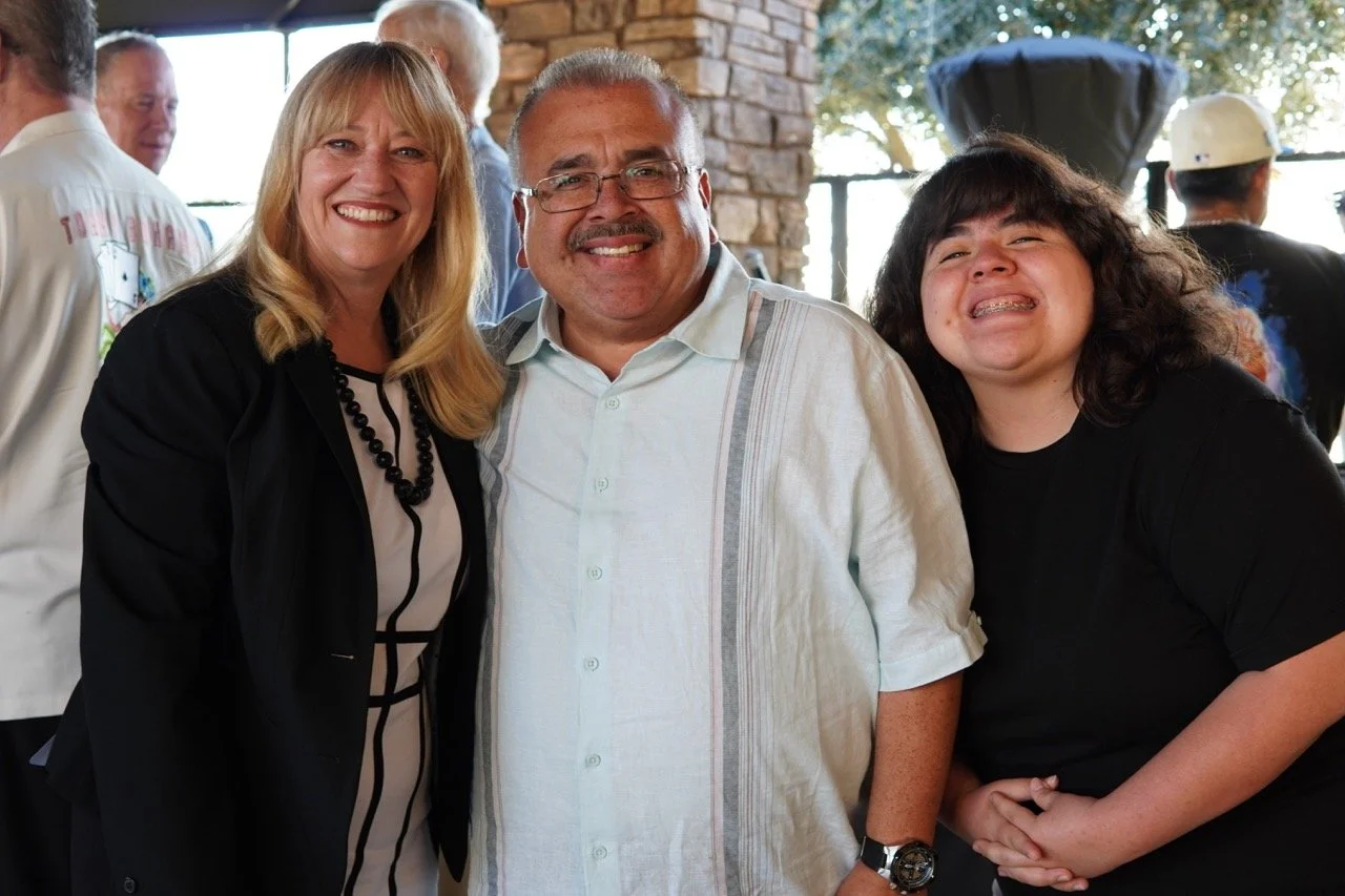 Israel Fuentes, Colton Joint Unified School District Board Member and daughter posing with Cali Binks.