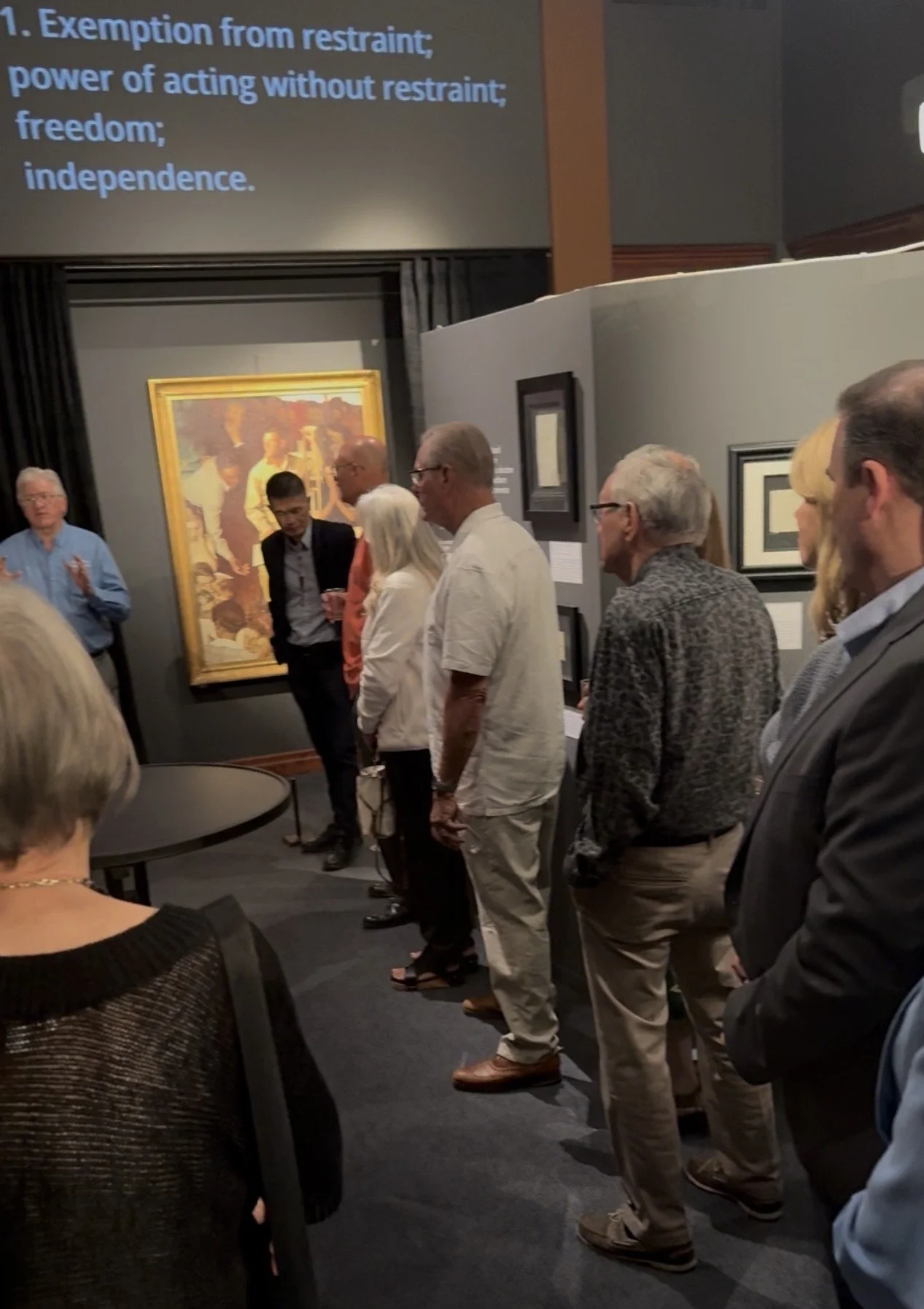 Group of adults touring the venue and hearing about the history of president Lincoln's time