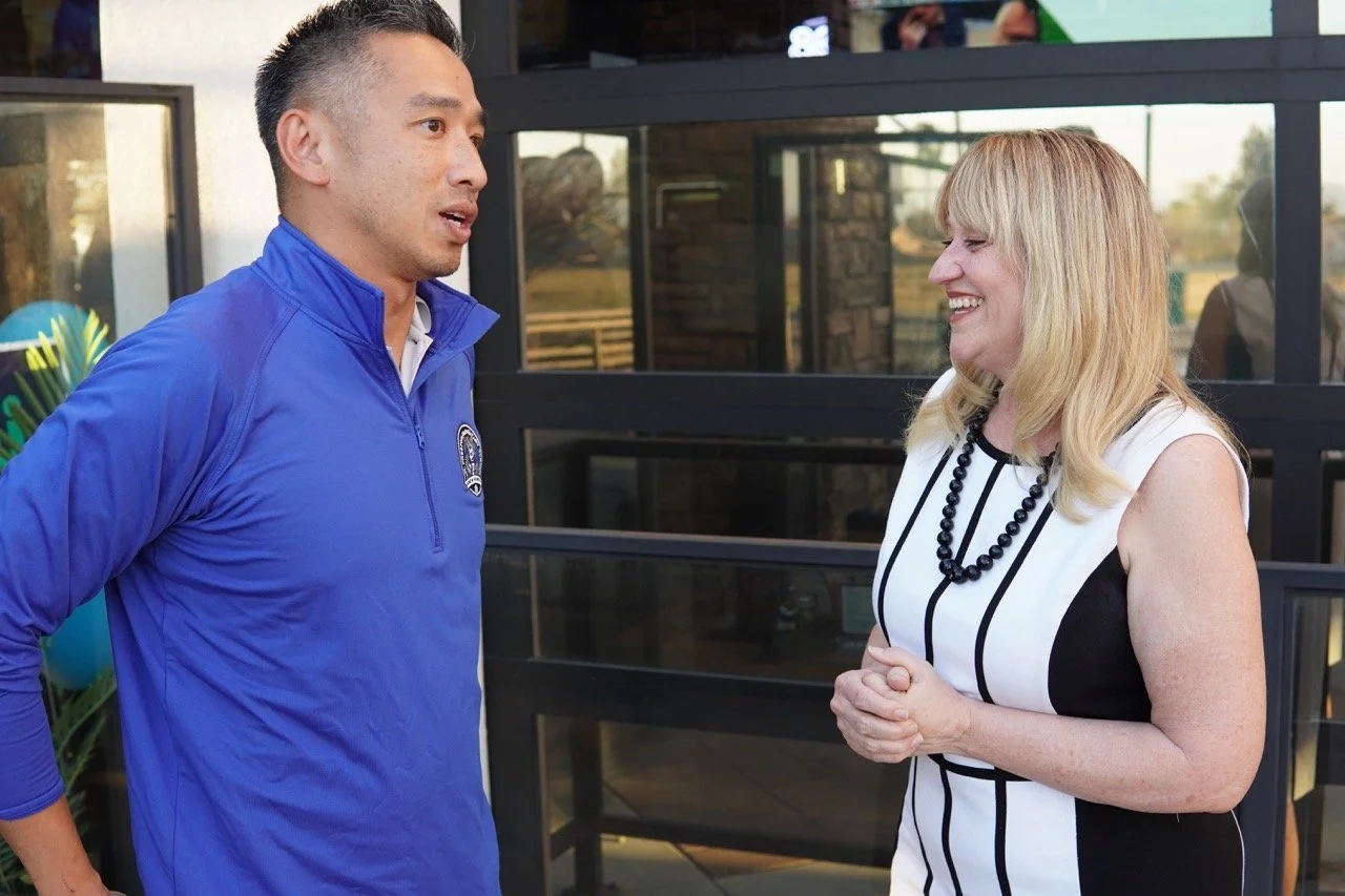 Cali smiling and speaking to a guest from Preston Elementary School.