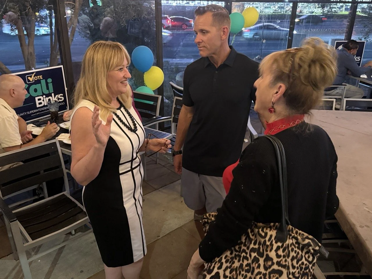 Cali networking with two community members and guests.